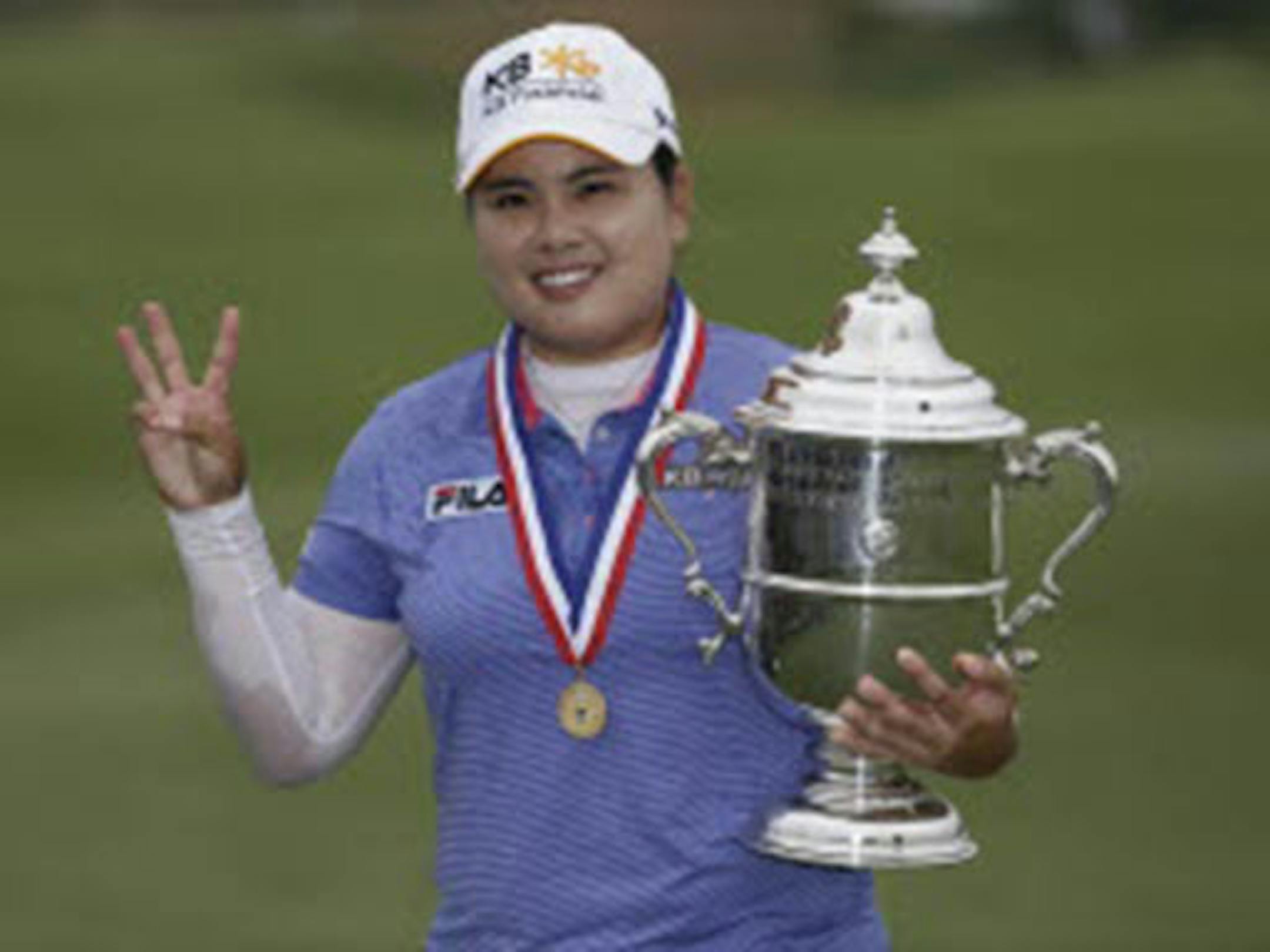 Inbee Park of South Korea held the championship trophy after winning the U.S. Women's Open golf tournament at Sebonack Golf Club on Sunday in Southampton, N.Y. Park has made history with titles in the year's first three majors.
