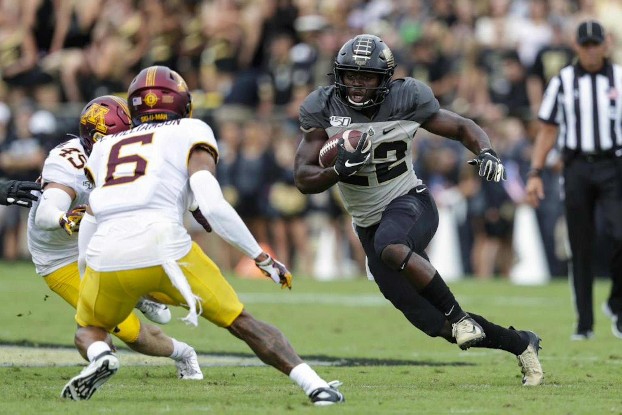 Purdue running back King Doerue (22) cuts away from Minnesota defensive back Chris Williamson (6) during the first half of an NCAA college football game in West Lafayette, Ind., Saturday, Sept. 28, 2019.