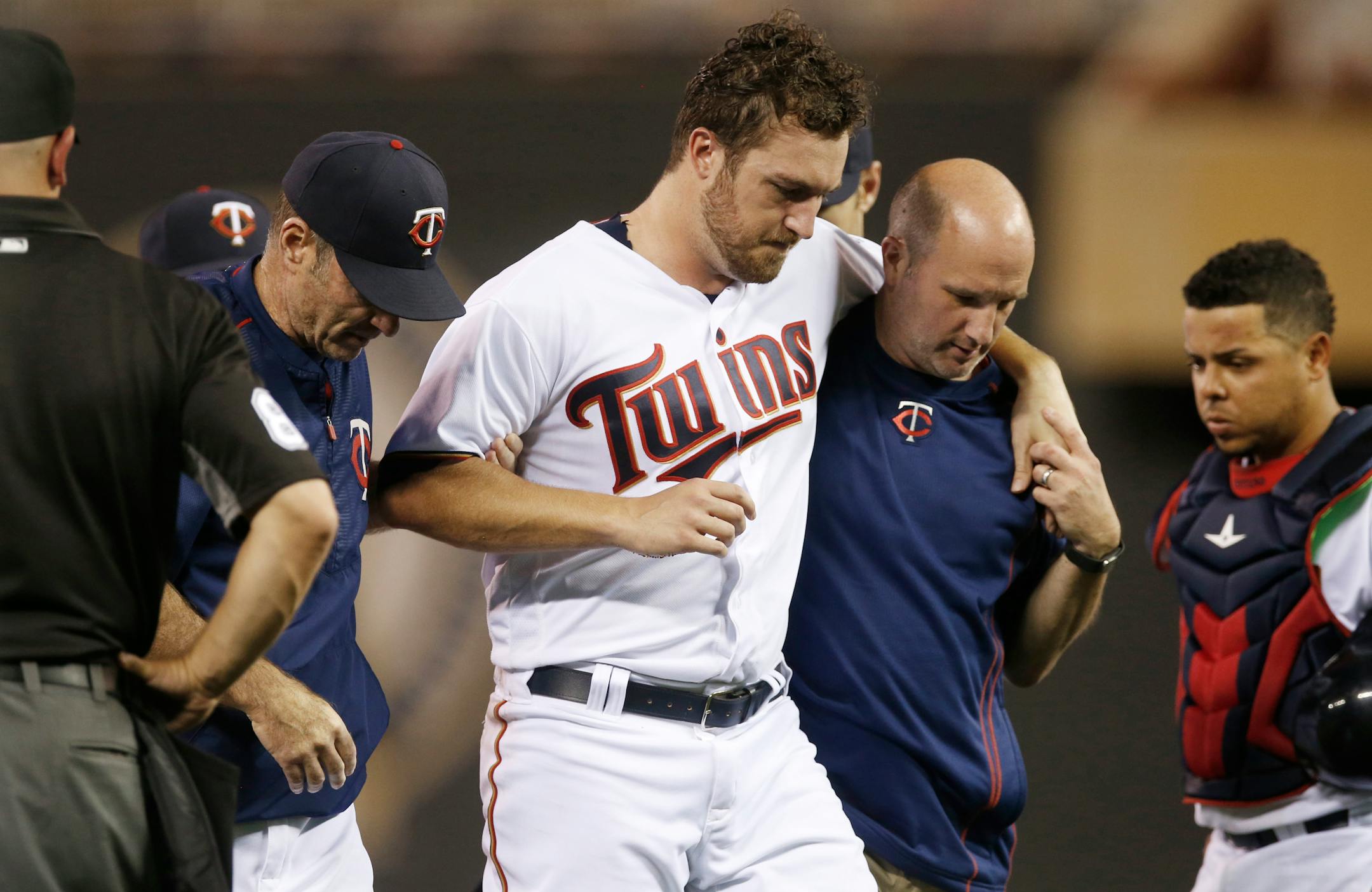 Minnesota Twins pitcher Phil Hughes is helped off the field by trainer Tony Leo, right, and manager Paul Molitor, left, after he was hit in the leg with a line drive on June 9. Hughes also had shoulder surgery July 6.