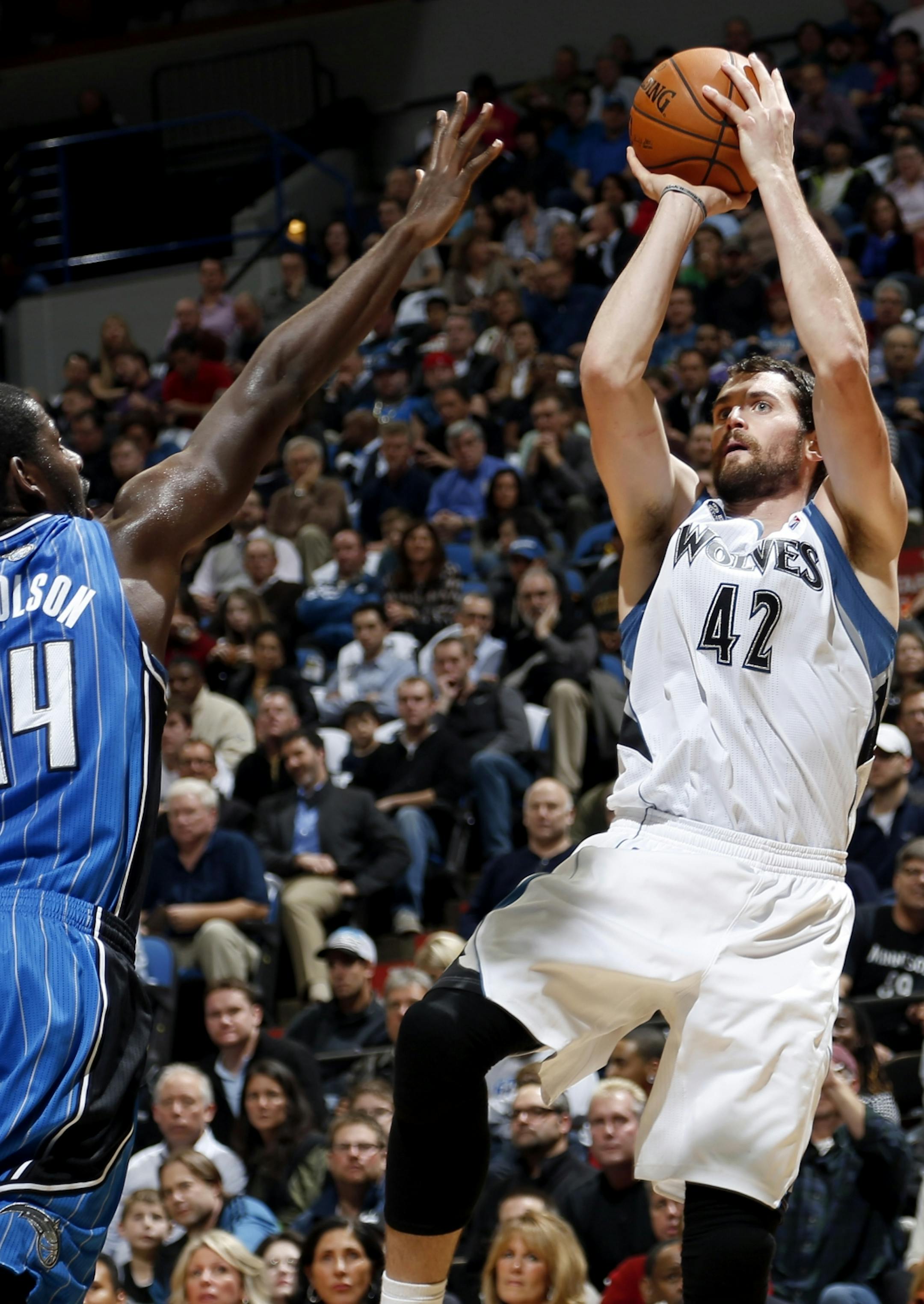 Minnesota Timberwolves Kevin Love (42) attempted a show while being defended by Andrew Nicholson (44) in the second quarter.