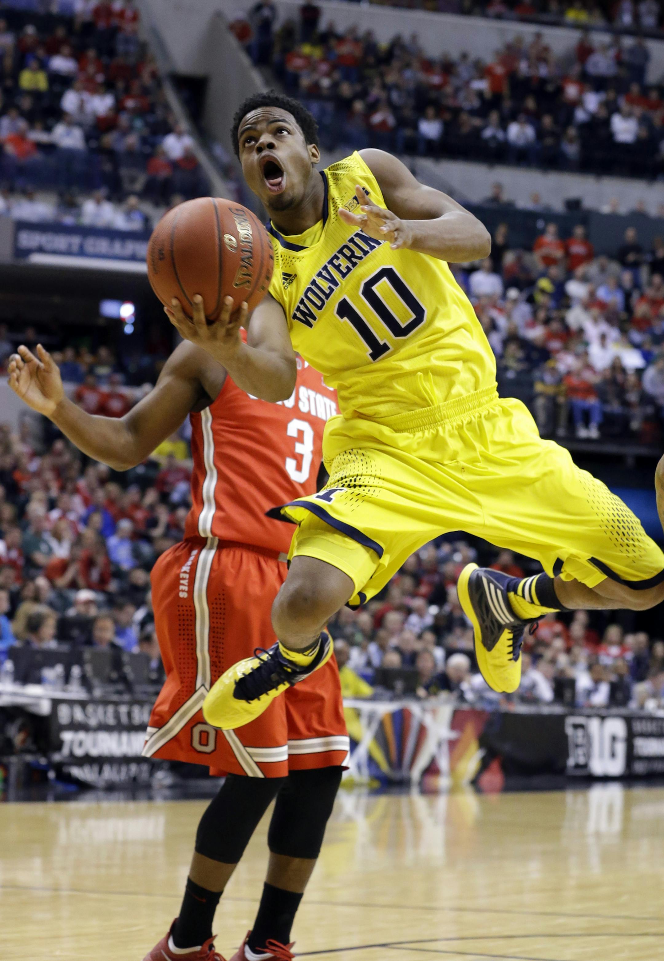 Michigan guard Derrick Walton Jr. goes up for a shot in the first half of an NCAA college basketball game against Ohio State in the semifinals of the Big Ten Conference tournament Saturday, March 15, 2014, in Indianapolis. (AP Photo/Michael Conroy)