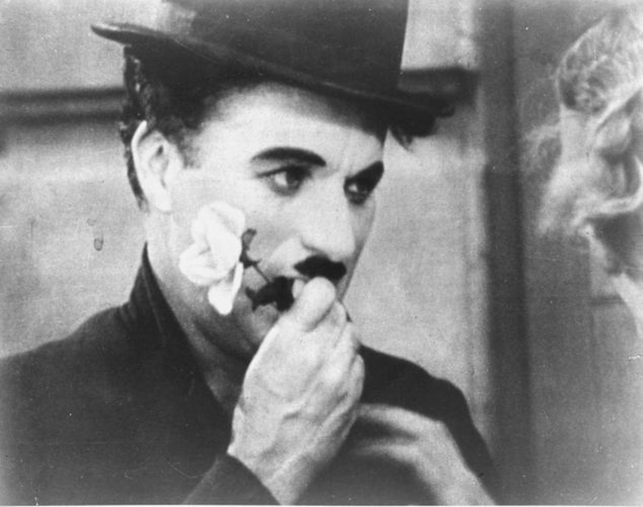 Charlie Chaplin holds a rose in this photo from the final scene in his 1931 silent film "City Lights". The film is among the American Film Institute's best romantic comedy movies.