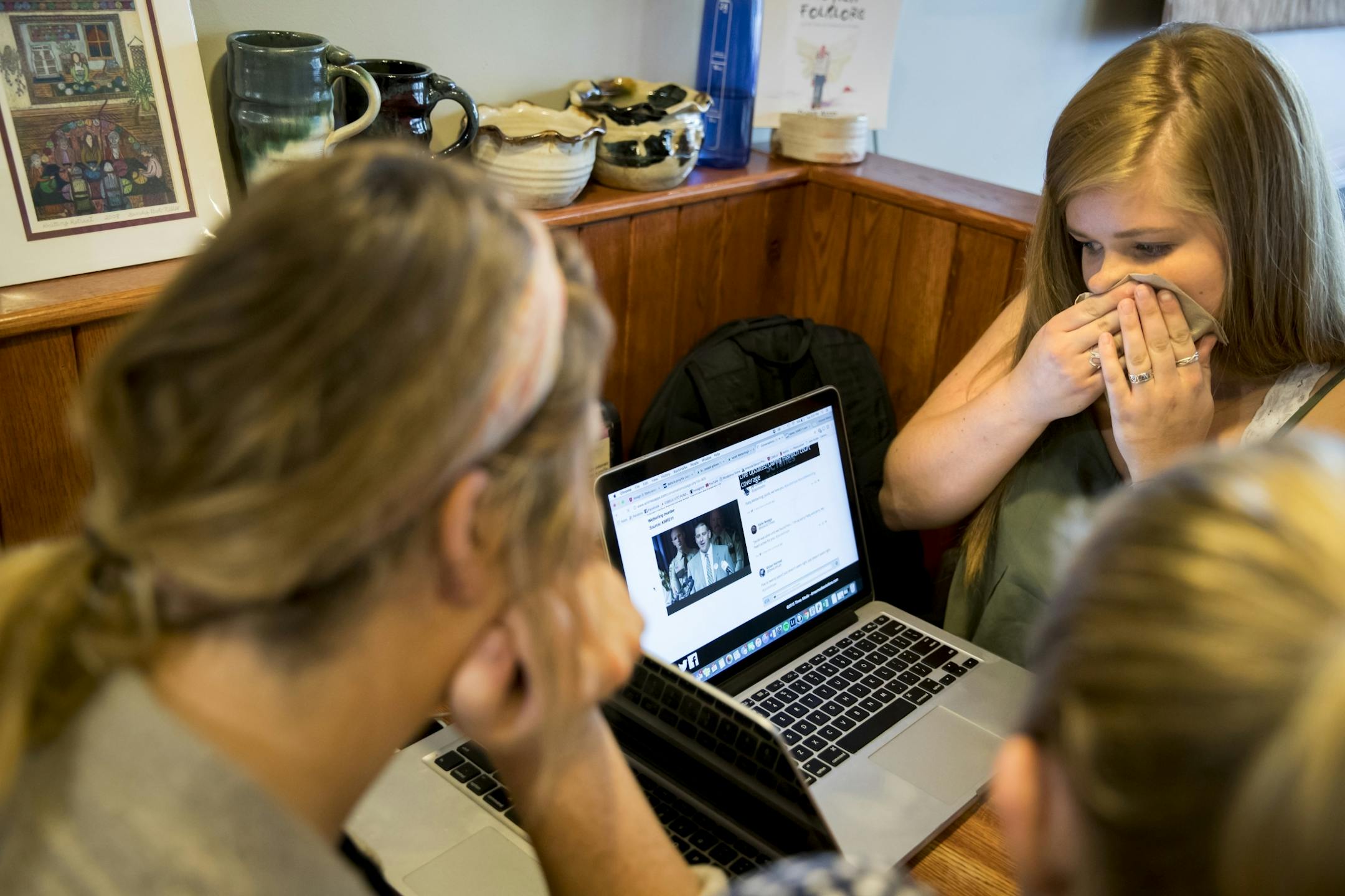 College of Saint Benedict's Amanda Baloun, of Sartell, wiped her face as she cried watching a press conference on a laptop of the confession of Danny Heinrich in the abduction and murder of Jacob Wetterling, with friends at the coffee shop The Local Blend in St. Joseph, Minn. on Tuesday, September 6, 2016.