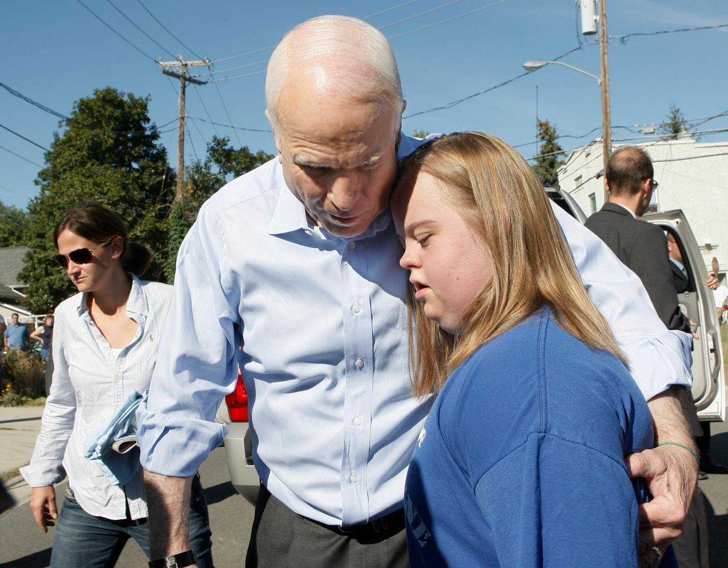 Republican presidential candidate John McCain hugged Tiffany Rochet on Monday after visiting the ISOH Impact organization in Waterville, Ohio, where he helped fill hurricane relief packages.