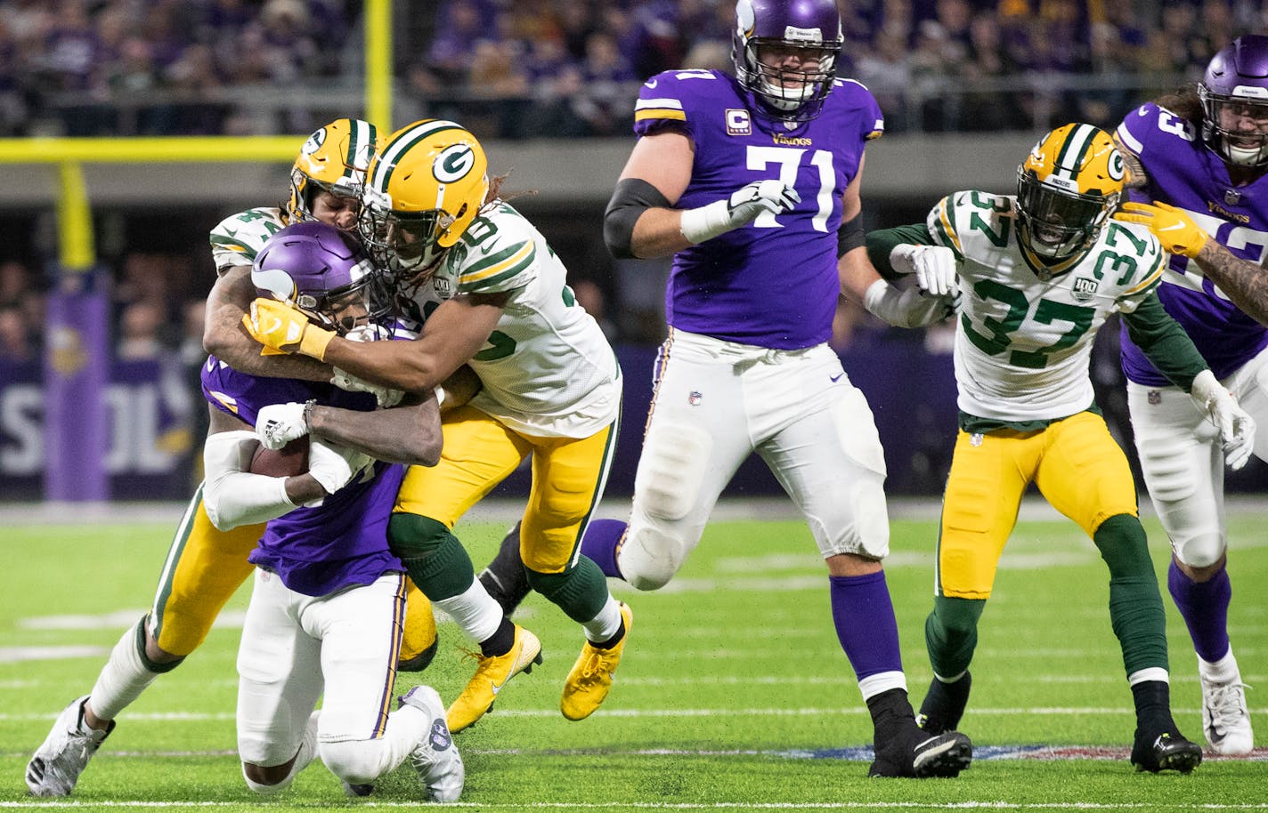 Vikings wide receiver Stefon Diggs was tackled by Packers cornerback Tramon Williams (38) and a teammate late in the third quarter