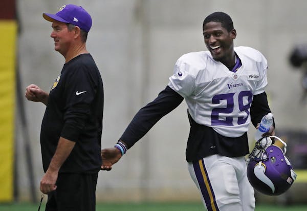 Vikings cornerback Xavier Rhodes chatted with head coach Mike Zimmer as he returned to practice Wednesday at Winter Park