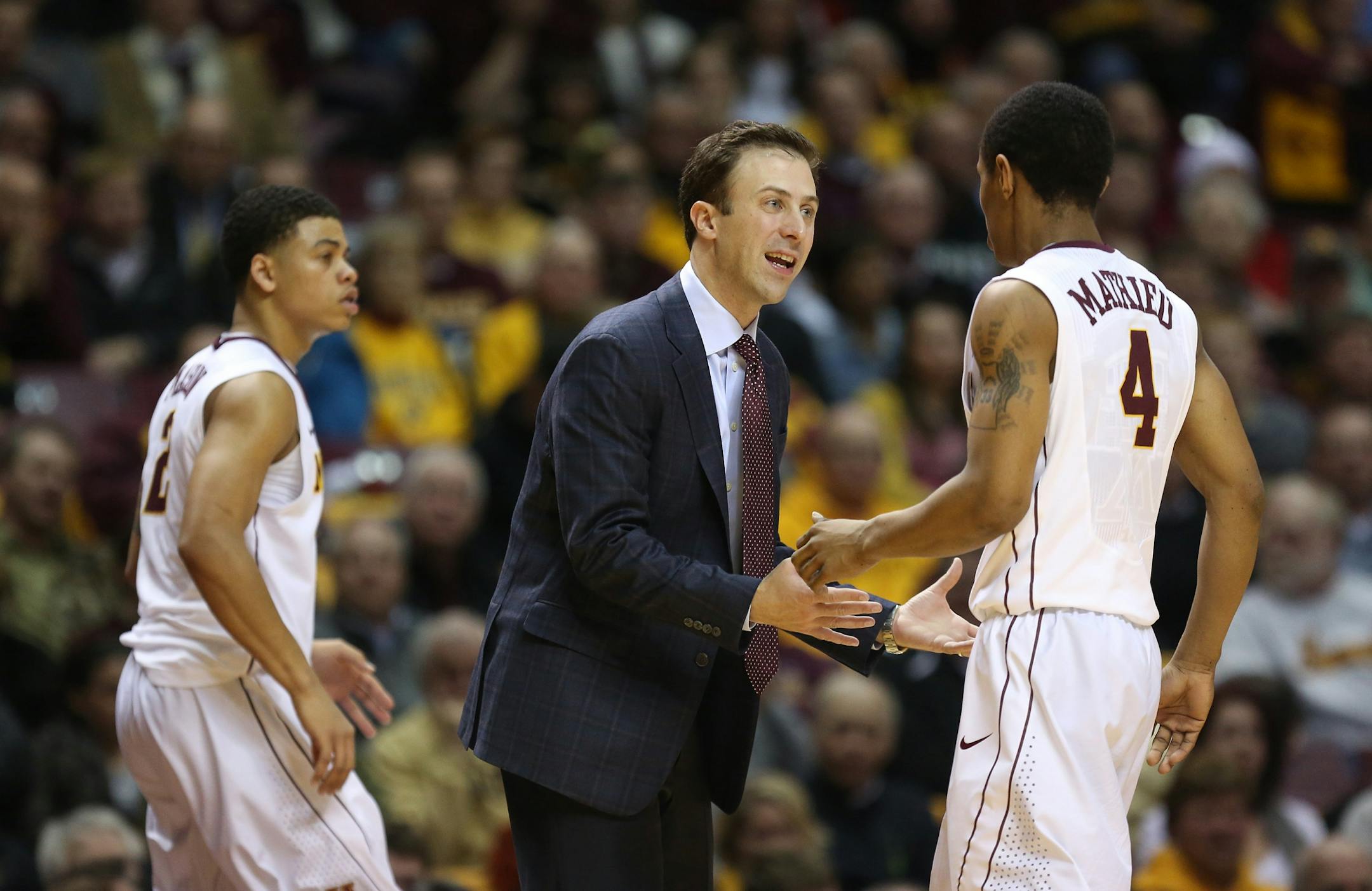 Gopher head coach Richard Pitino talked with player DeAndre Mathiue during a timeout during a February game.