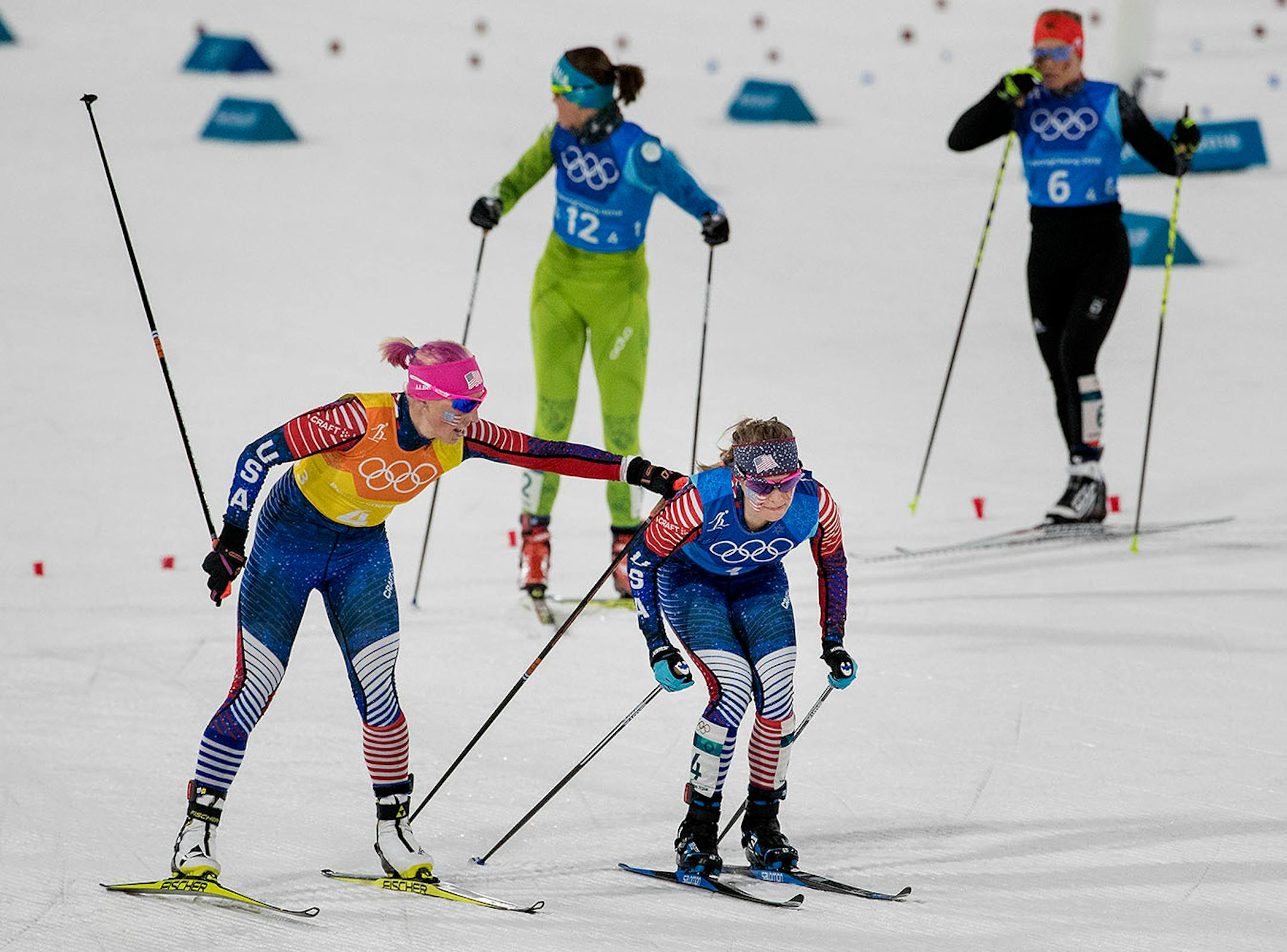 The United States' Kikkan Randall, left, touches teammate Jessie Diggins during an exchange in the Women's 4x5km Relay at Alpensia Cross-Country Centre during the Pyeongchang Winter Olympics on Saturday, Feb. 17, 2018.