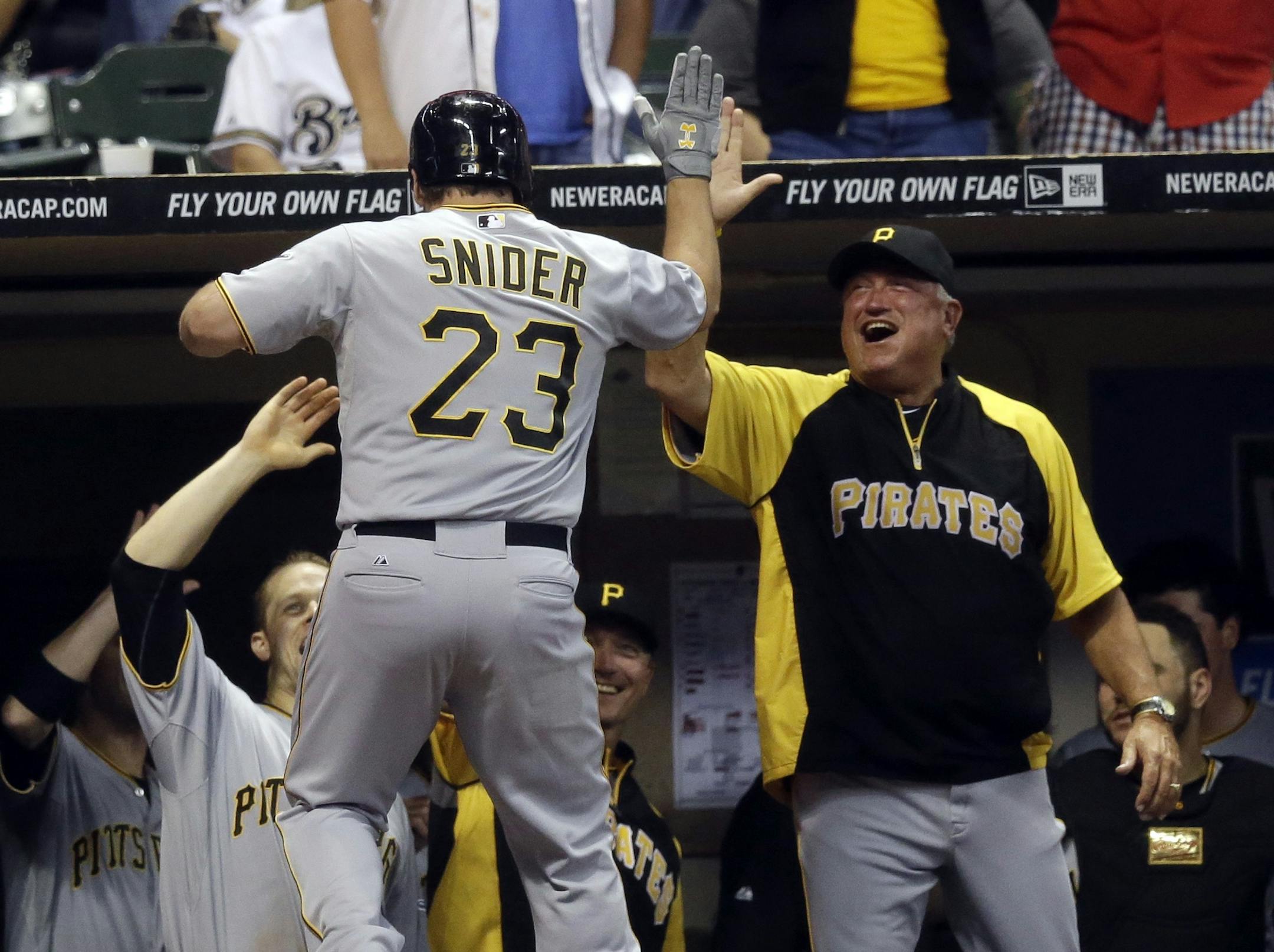 Pittsburgh Pirates manager Clint Hurdle congratulates Travis Snider (23) after Snider's home run during the ninth inning of a baseball game against the Milwaukee Brewers Tuesday, Sept. 3, 2013, in Milwaukee. (AP Photo/Morry Gash) ORG XMIT: MIN2013092721443949