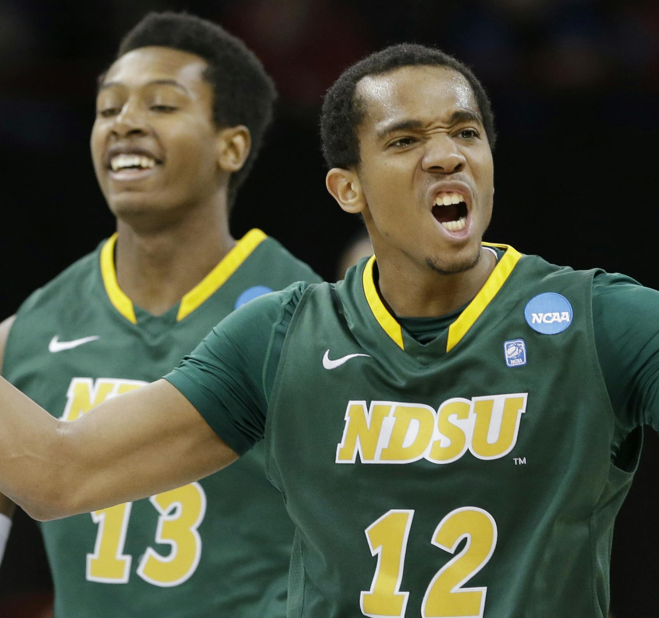 North Dakota State's Lawrence Alexander (12) celebrates in overtime during a second-round game against Oklahoma in the NCAA men's college basketball tournament in Spokane, Wash., Thursday, March 20, 2014. North Dakota State won 80-75. (AP Photo/Elaine Thompson)