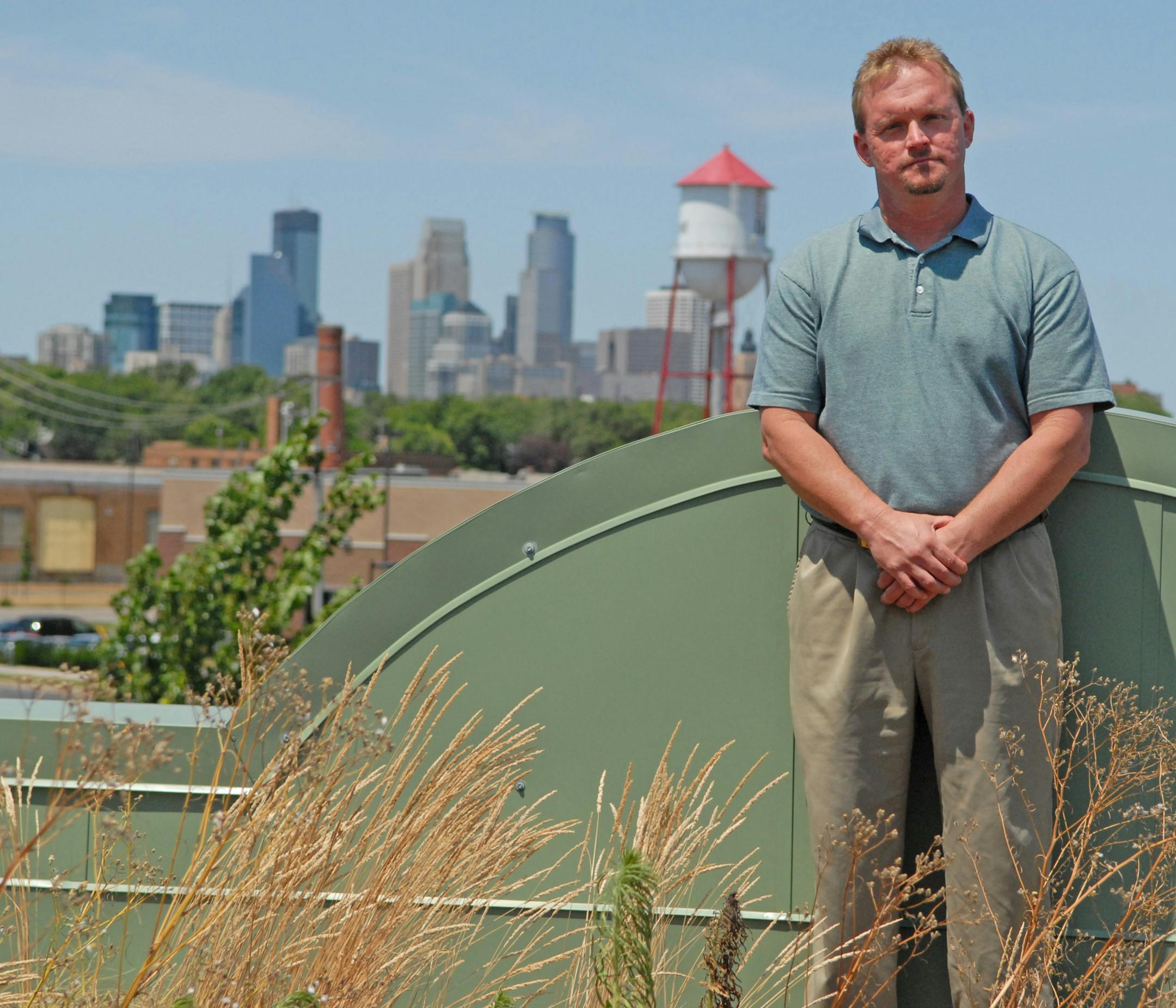 Jamie Heipel stands in the loby of the Green Institute The Green Institute is behind on its loans and trying to cut costs enough to stay in business. Heipel has been working for the past several months to try to right a financially shaky situation. Like to get a shot of him with the Phillips Eco-Enterprise Center that the Institute built, and where it has its office. The institute is in some danger of losing the facility to foreclosure.