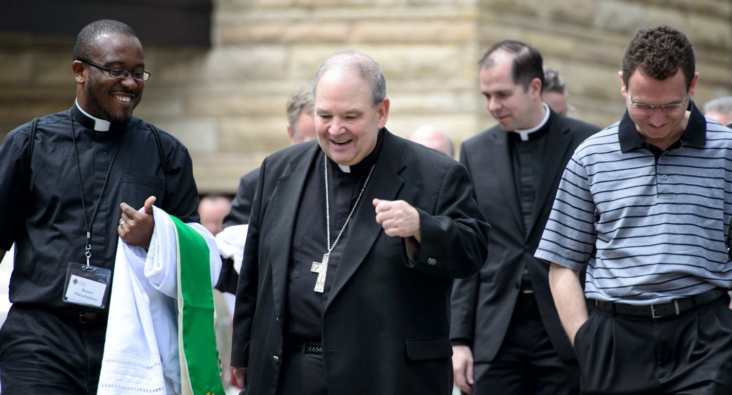 Interim Archbishop Bernard Hebda left St. John the Evangelist Church in Rochester with priests, including the Rev. Bruno Nwachukwu, left, and Auxiliary Bishop Andrew Cozzens, right. One priest described the service there as a &#x201c;meeting of brothers.&#x201d;