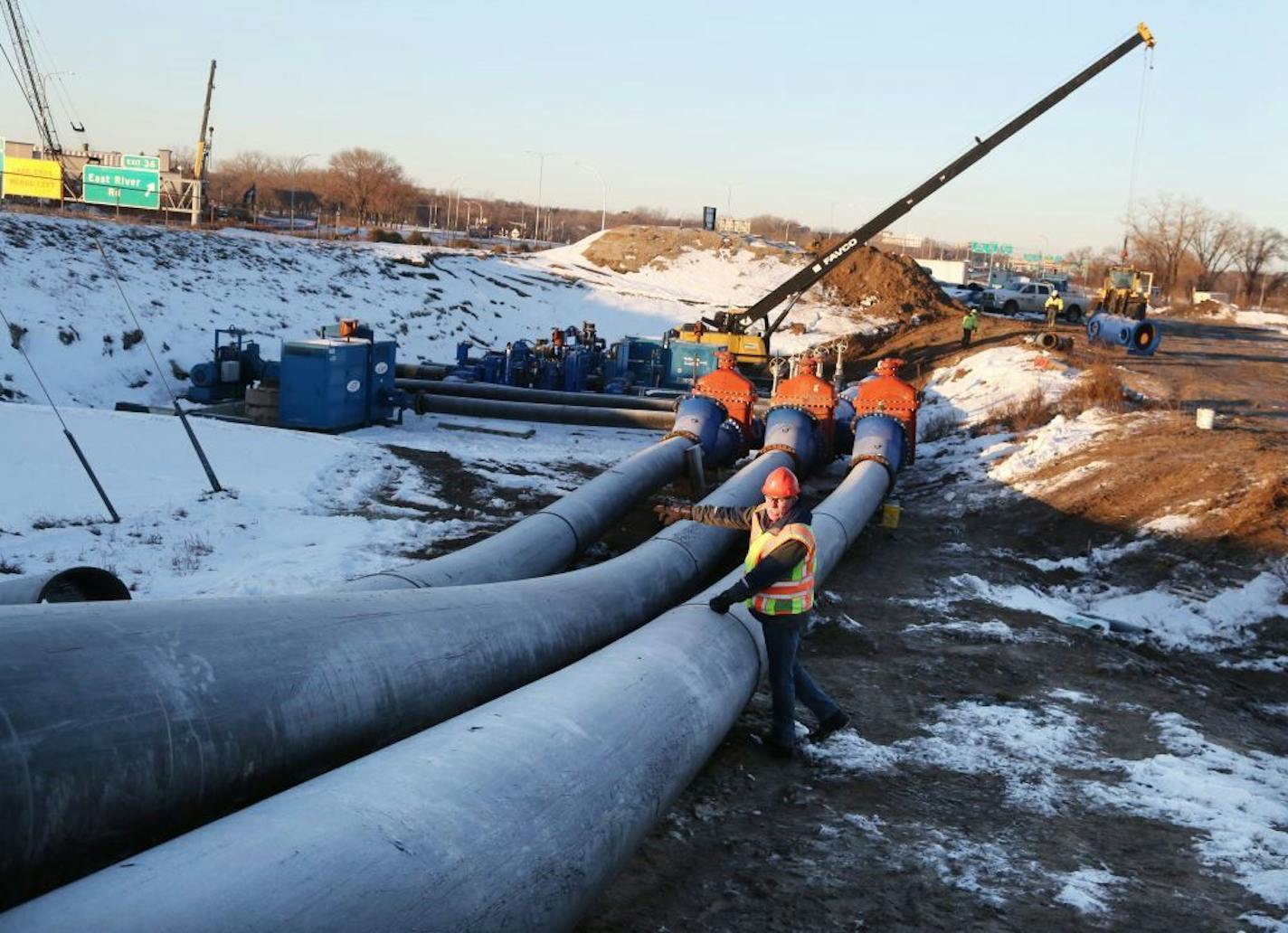 Construction crews are now setting up a large temporary wastewater pumping and piping system to convey wastewater around a large sewer under I-694 that we will repair in January. The current work involves excavation and placement of about 15 large pumps. Each day two hundred and fifty million gallons of water and waste is pumped through the Met Council system to eight treatment plants in the metro--enough to fill the entire Empire State Building daily. Here, Tim O'Donnell, Met Council Environmen