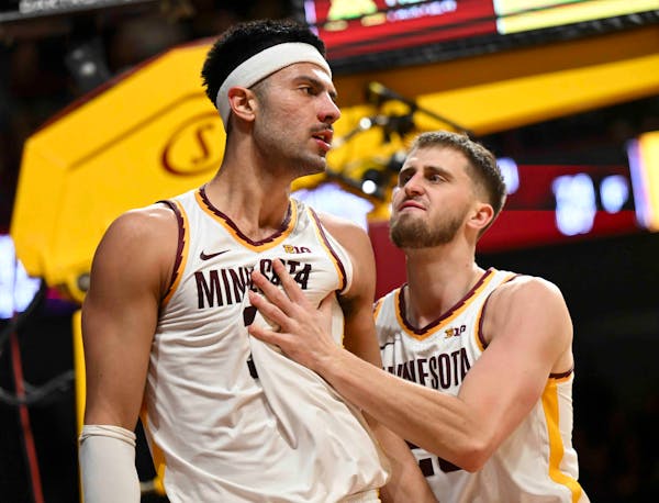 Minnesota Gophers forward Dawson Garcia (3) and forward Parker Fox (23) celebrate an and-one opportunity by Garcia in the second half Monday, Jan. 15,