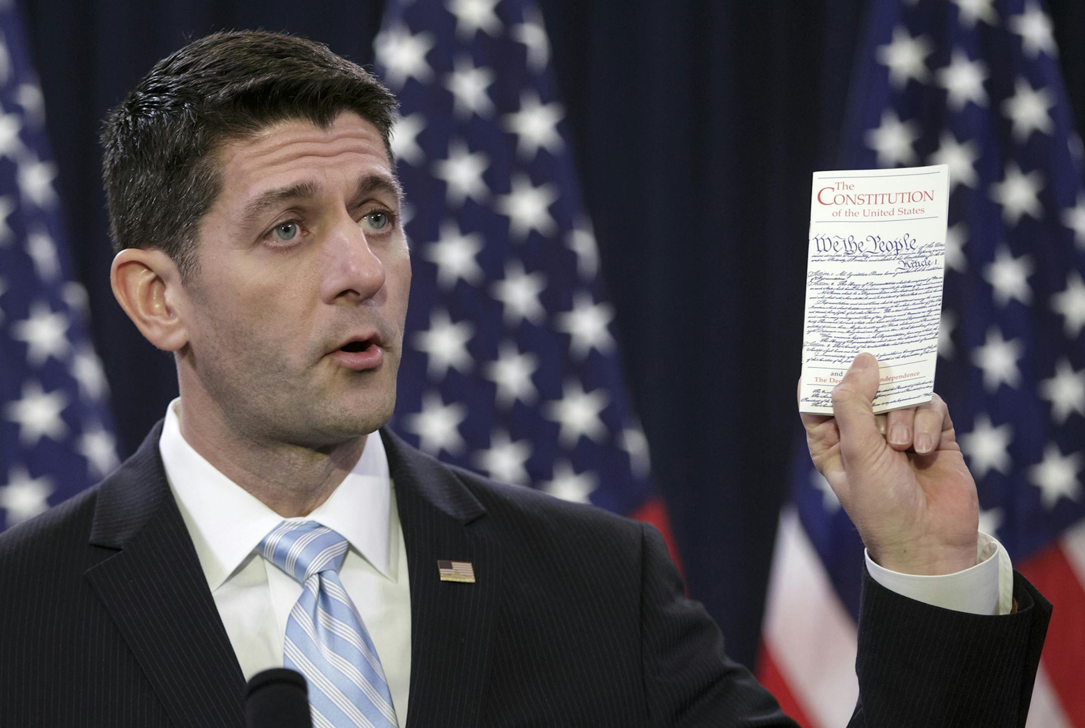 House Speaker Paul Ryan of Wis. holds a copy of the Constitution as he decries ugliness and divisiveness in American politics, delivering a veiled but passionate rebuke to GOP presidential front-runner Donald Trump and the nasty tone of the presidential campaign as he addressed congressional interns, Wednesday, March 23, 2016, on Capitol Hill in Washington. (AP Photo/J. Scott Applewhite) ORG XMIT: MIN2016032415501836