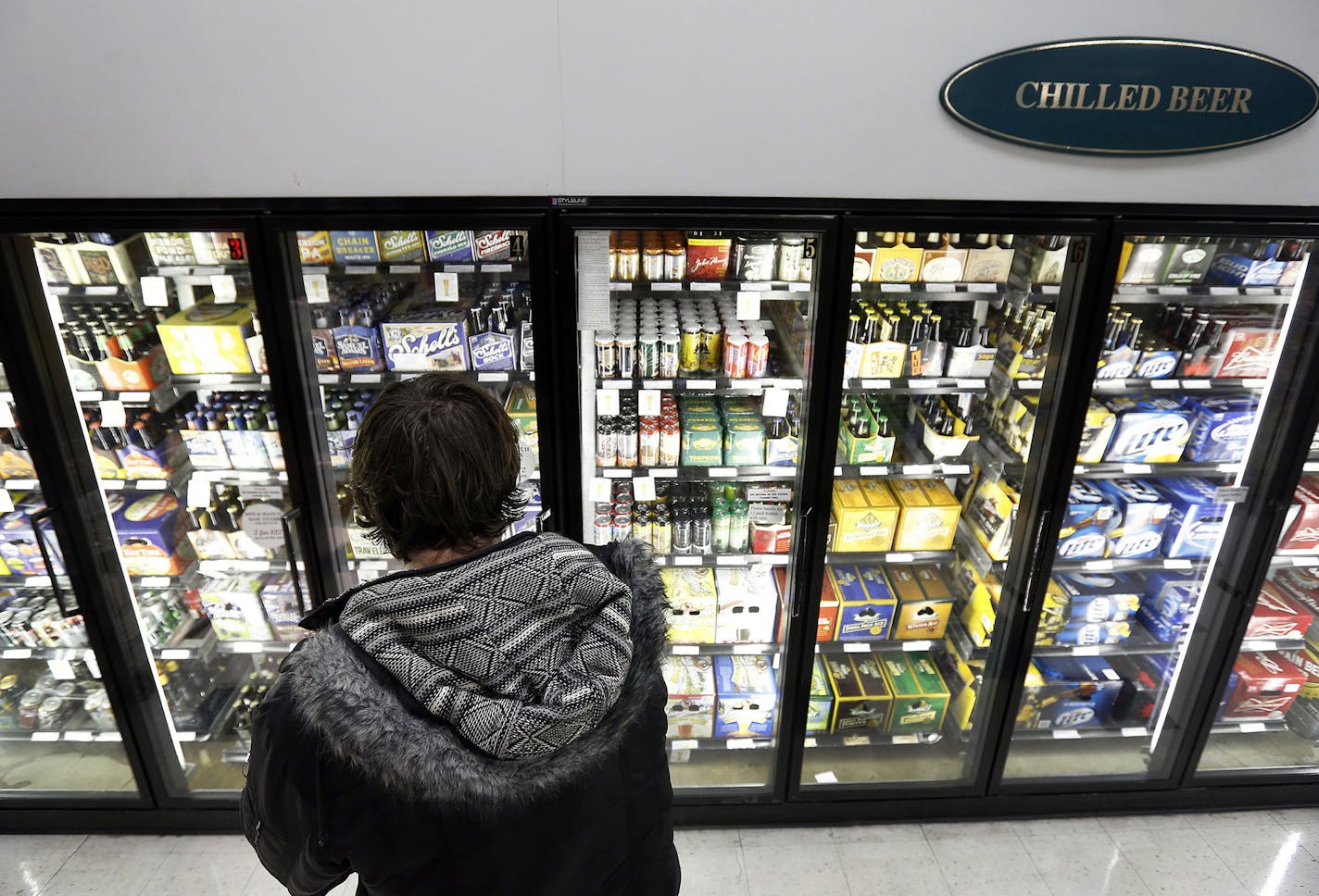 Christopher Hunt, 32, of Minneapolis shopped for beer at Surdyk's in Northeast Minneapolis on Monday. ] CARLOS GONZALEZ cgonzalez@startribune.com - February 4, 2013, Minneapolis, Minn., Surdyk's liquor store, story about the push to legalize Sunday liquor sales in Minnesota. ORG XMIT: MIN1302041712351382 ORG XMIT: MIN1403131557140354