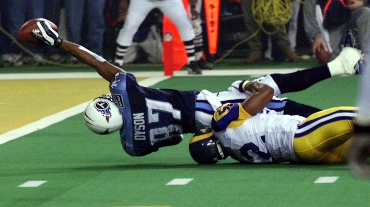 FILE - In this Jan. 30, 2000, file photo, Tennessee Titans wide receiver Kevin Dyson (87) tries but fails to get the ball into the end zone as he is tackled by St. Louis Rams' Mike Jones on the final play of NFL football's Super Bowl XXXIV in Atlanta. The Rams won 23-16. (AP Photo/John Gaps III, File)