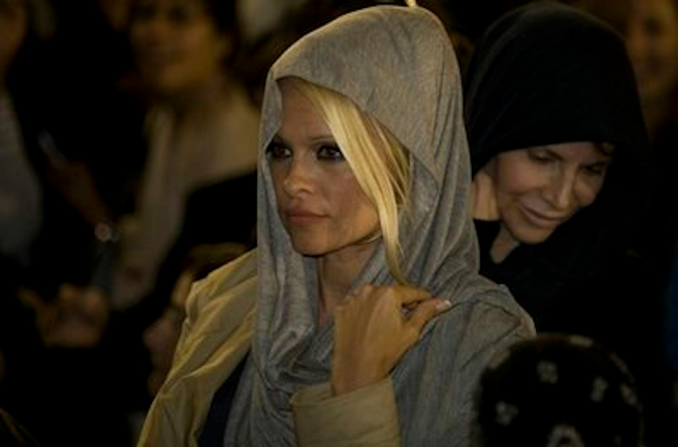 U.S. actress Pamela Anderson is seen at the Western Wall, Judiasm's holiest site, in Jerusalem's Old City, Sunday, Nov. 7, 2010.  Former "Baywatch" star Pamela Anderson said Sunday she will try her powers of seduction while in Israel on an unlikely audience,  ultra-Orthodox Jewish lawmakers. Anderson, an honorary director of People for the Ethical Treatment of Animals, is in Israel to participate in the local version of "Dancing with the Stars." (AP Photo/Sebastan Scheiner)