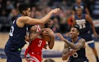 Minnesota Timberwolves center Karl-Anthony Towns (32) and guard Jeff Teague (0) fouled Rockets guard Chris Paul (3) late in the fourth quarter.