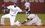 The Twins' Brian Dozier stole second base as Royals shortstop Alcides Escobar got a late throw during the fifth inning Tuesday.