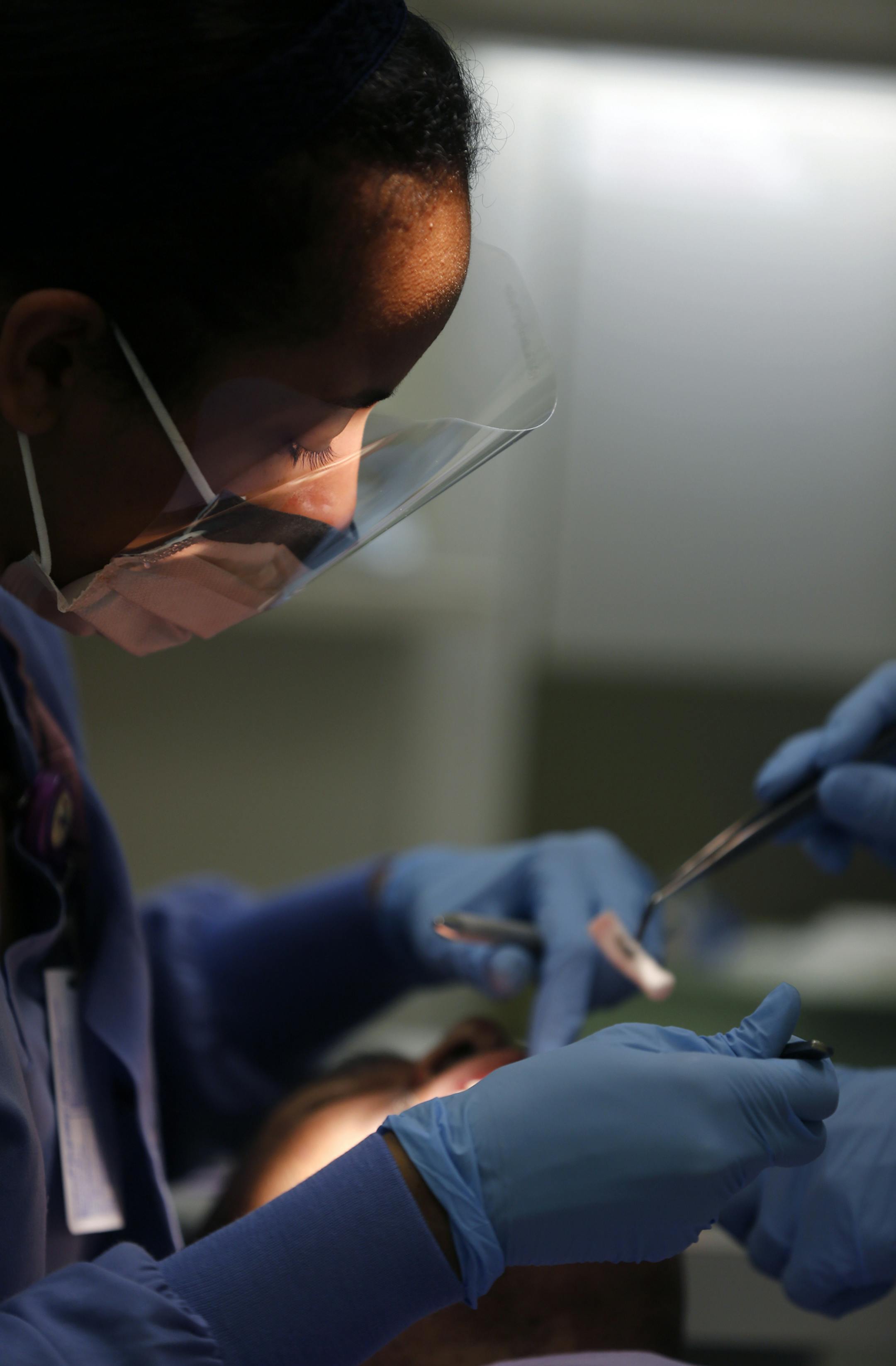 At the dental offices of HCMC, resident dentist Asmeret Tefahun worked on a filling for a patient who DID have insurance. The clinic also serves many indigent patients, but none was there when the photographer visited. Larger medical issues can stem from indigent who receive little or no dental care. ]rtsong-taatarii@startribune.com