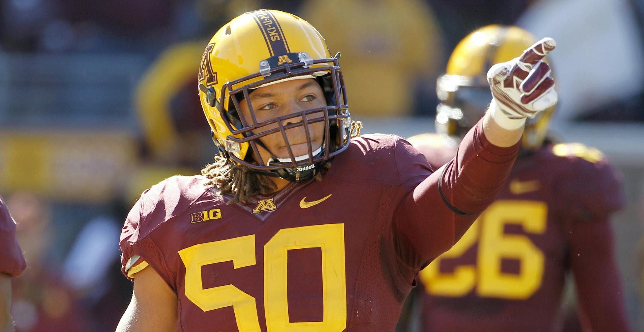 Minnesota linebacker Jack Lynn (50) gestures to the fans during the second quarter of an NCAA college football game against Northwestern in Minneapolis Saturday, Oct. 11, 2014. (AP Photo/Ann Heisenfelt) ORG XMIT: MIN2014101720271370