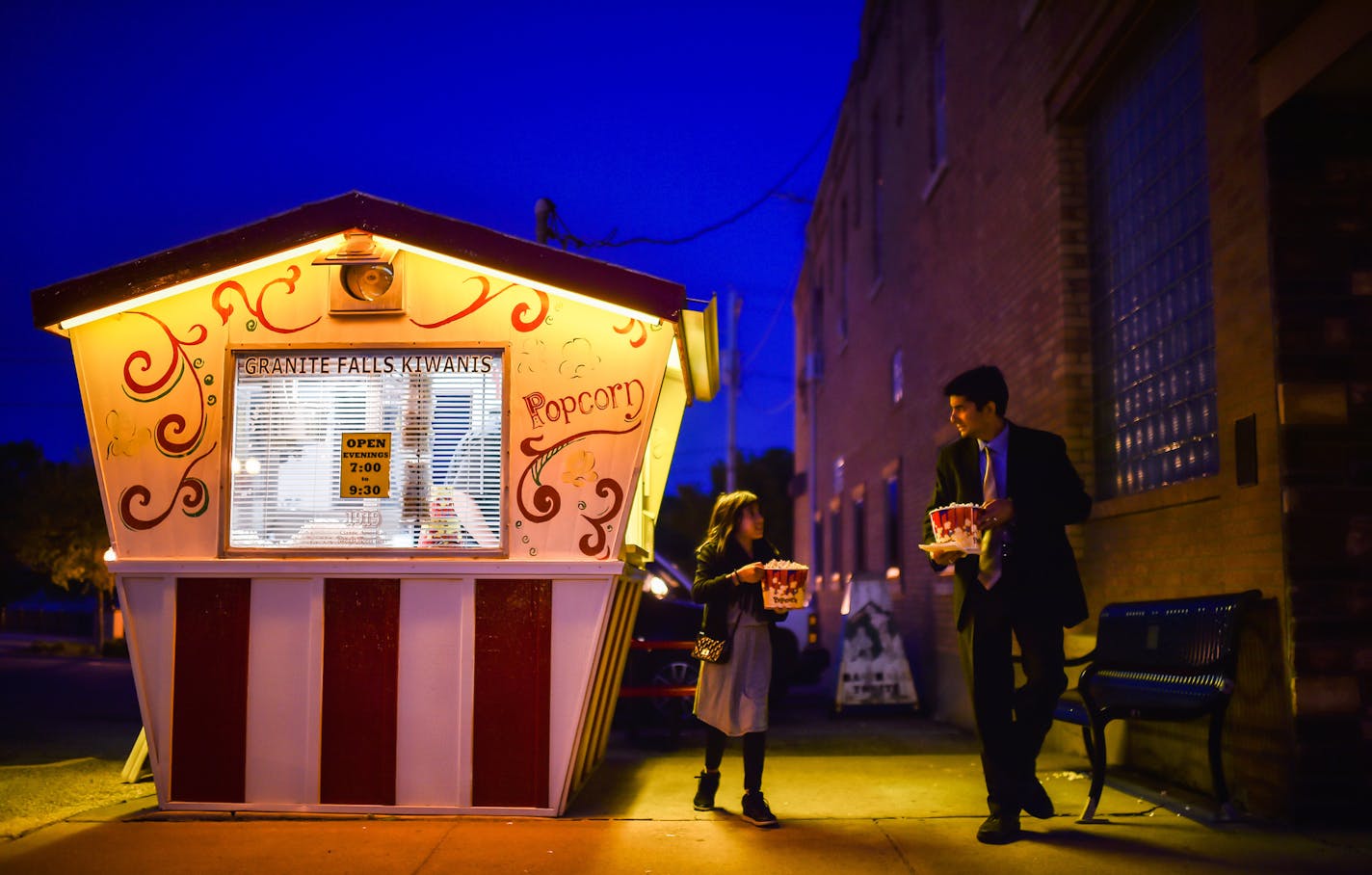 Dr. Ayaz Virji and his daughter, Maya, made a stop at a popcorn stand after his lecture on Islam at the Granite Falls, Minn., City Hall.