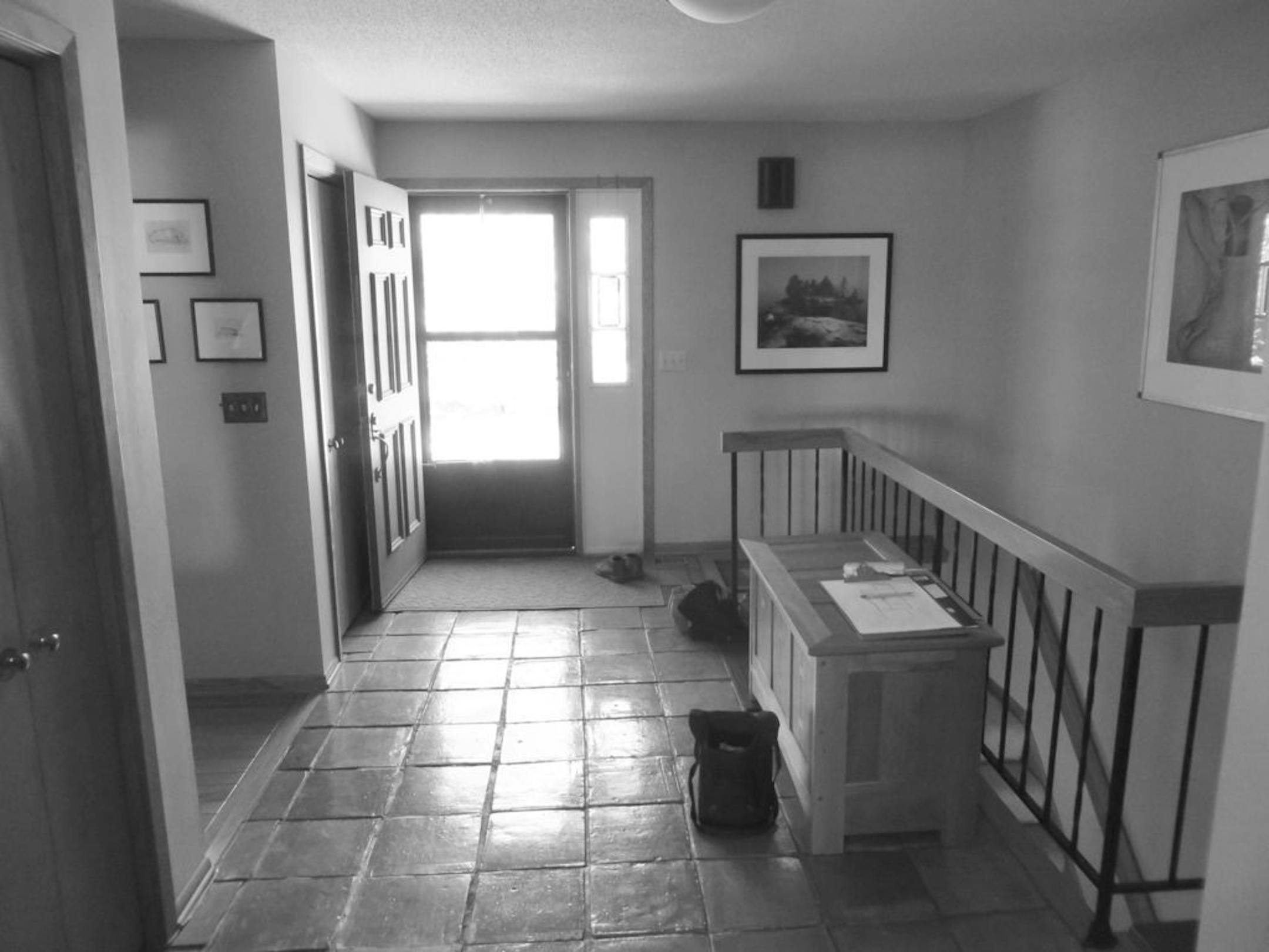 BEFORE:The front entry was dark, with an uneven tile floor.