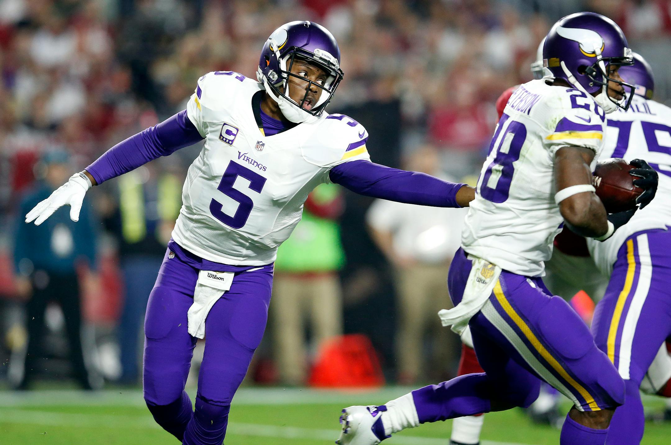 Vikings quarterback Teddy Bridgewater (5) hands the ball off to Adrian Peterson (28) in the second quarter against the Arizona Cardinals on Thursday, Dec. 10, 2015, at University of Phoenix Stadium in Glendale, Ariz.