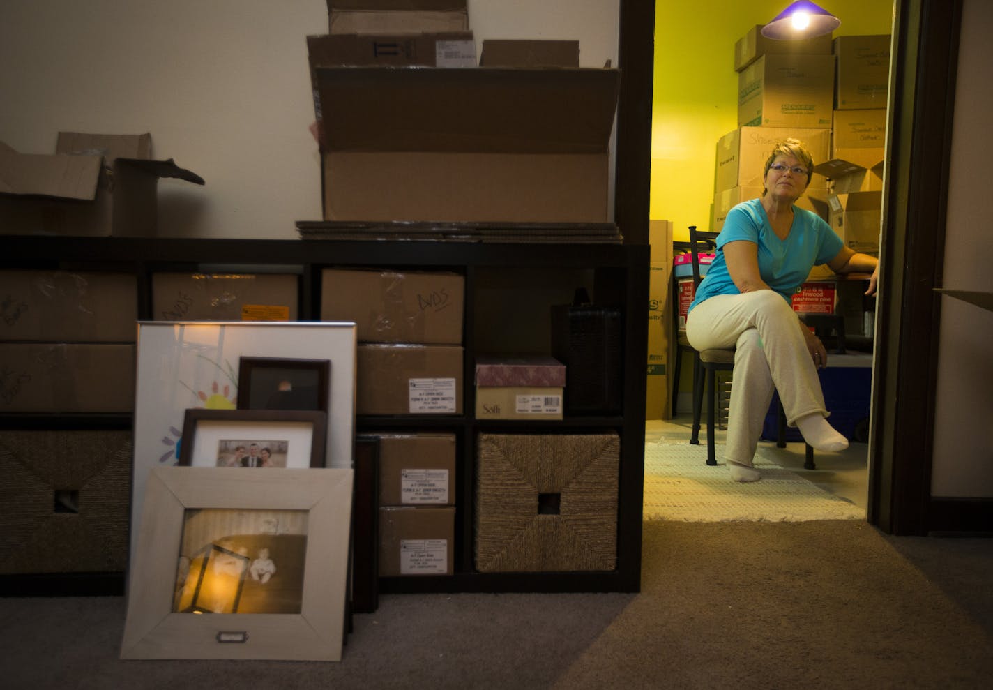 Darla Butler, 55, sat in her kitchen in the Alden apartments, with her belongings boxed up for her move in February after her lease was not renewed.