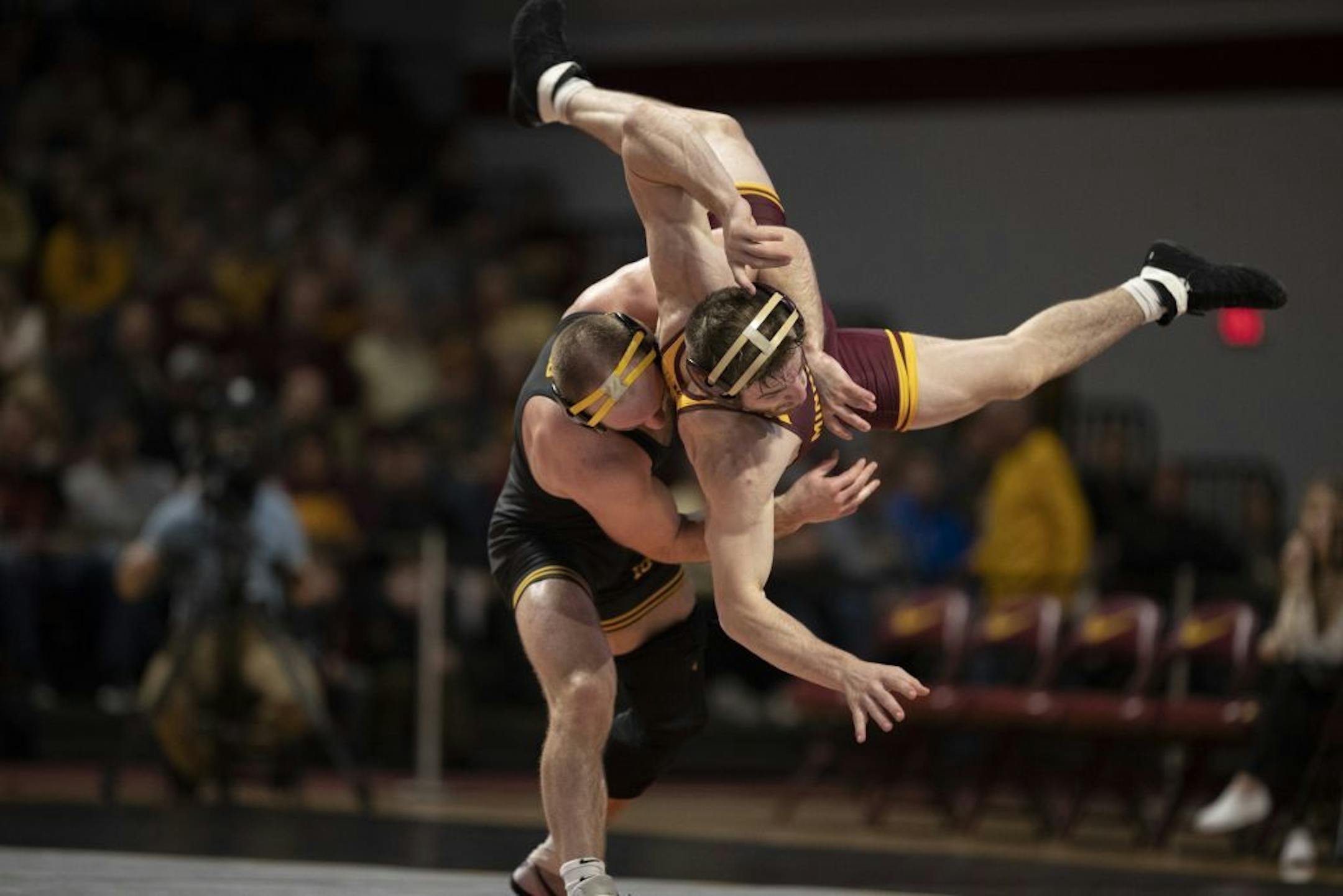 Iowa's Alex Marinellie took down the Gophers' Carson Brolsma for two points during a Big Ten wrestling match at a sold-out Maturi Pavilion on Sunday.