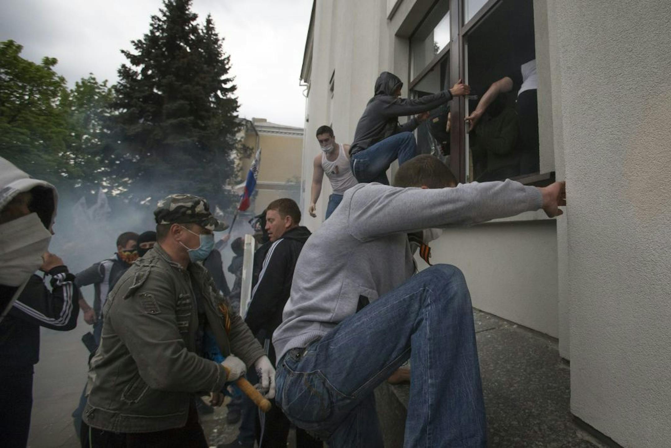Pro-Russian activists storm an administration building in the center of Luhansk, Ukraine, one of the largest cities in Ukraine's troubled east, Tuesday, April 29, 2014.