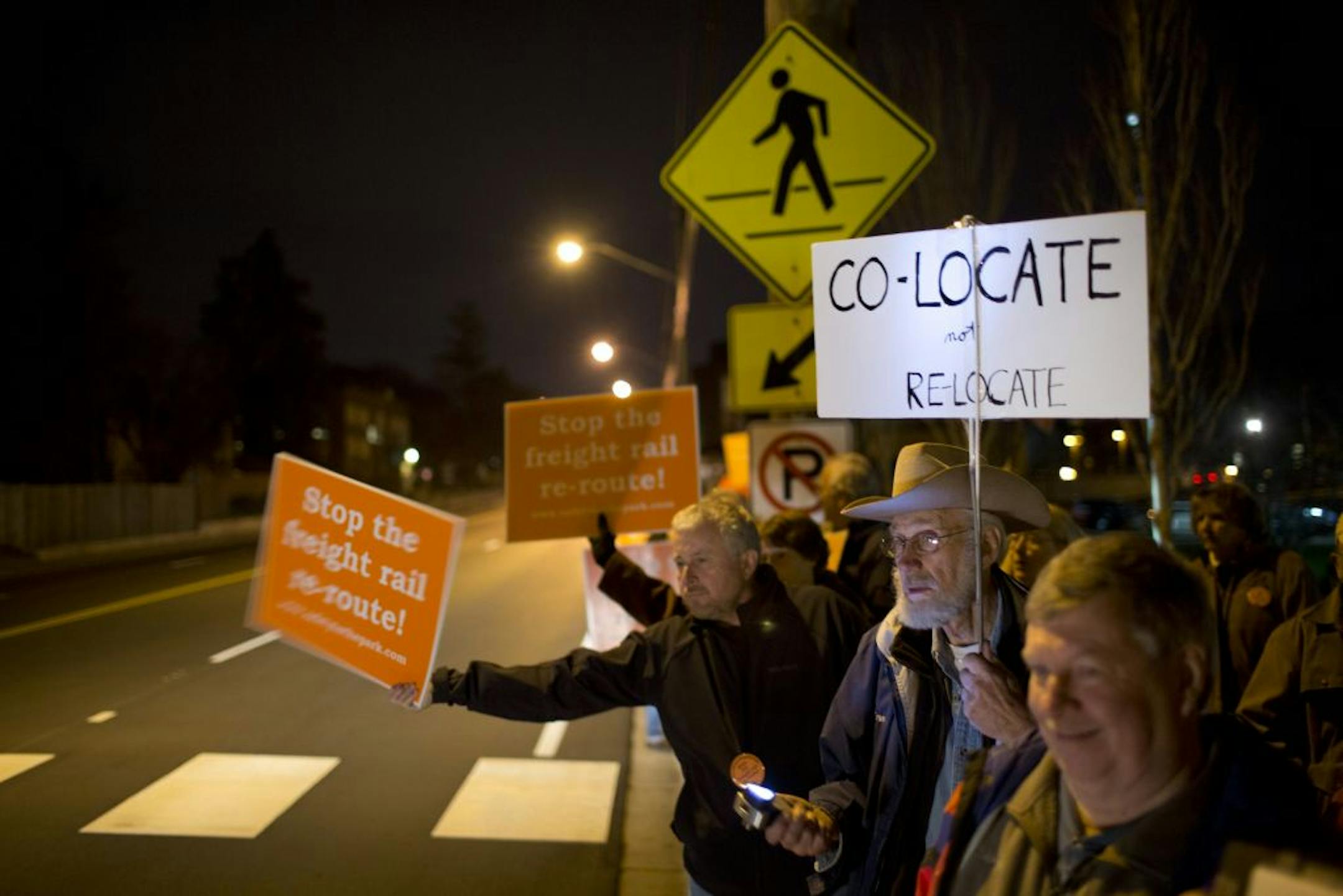 Scores of people demonstrated against a plan to reroute freight trains through their neighborhoods as a public hearing at St. Louis Park's City Hall was set to begin. Some cited safety concerns over the Southwest light-rail rerouting proposal.