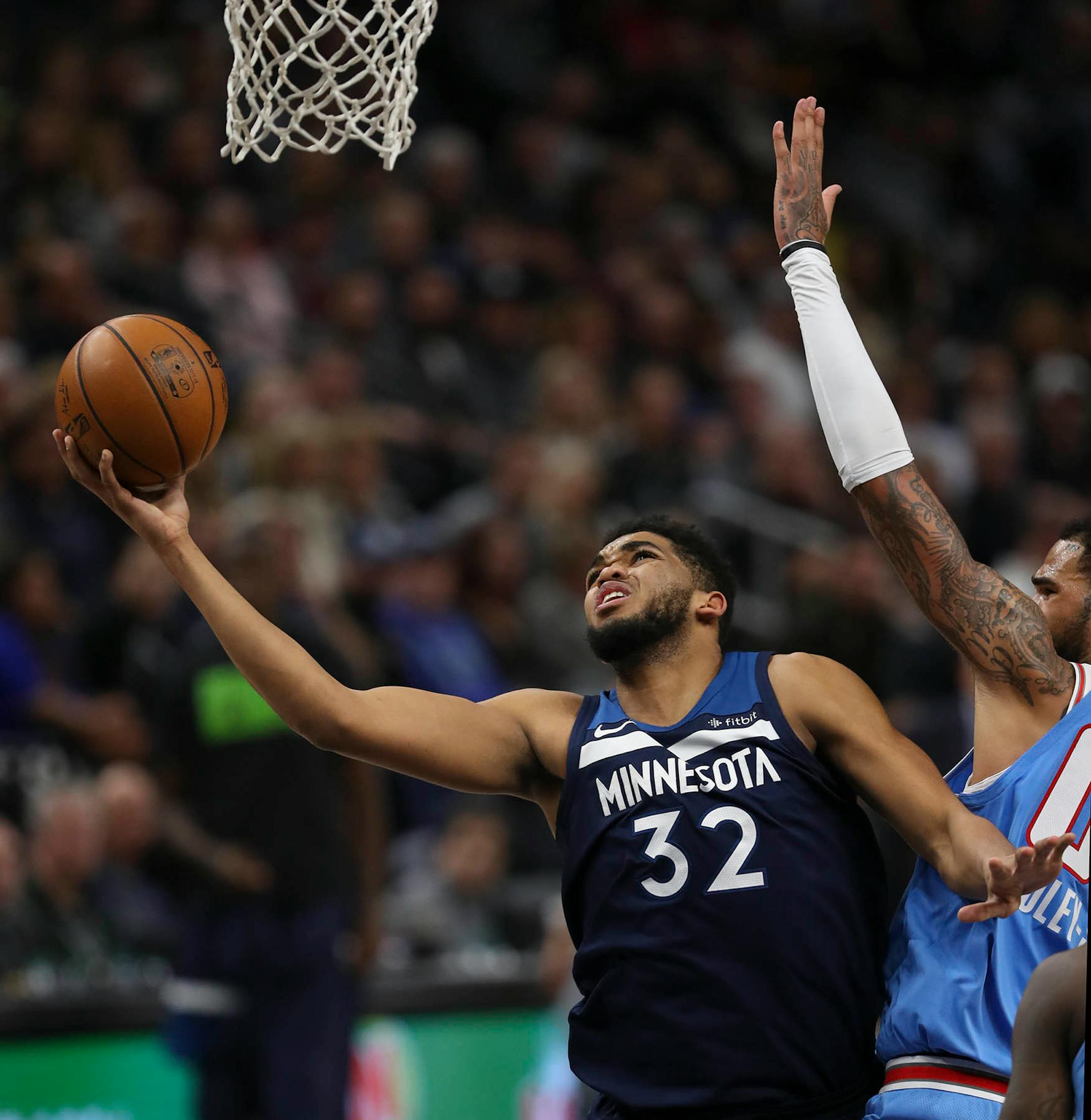 Minnesota Timberwolves center Karl-Anthony Towns (32) held off Sacramento Kings center Willie Cauley-Stein (00) while shooting under the net in the third quarter. Towns led all scorers with his 29 points.