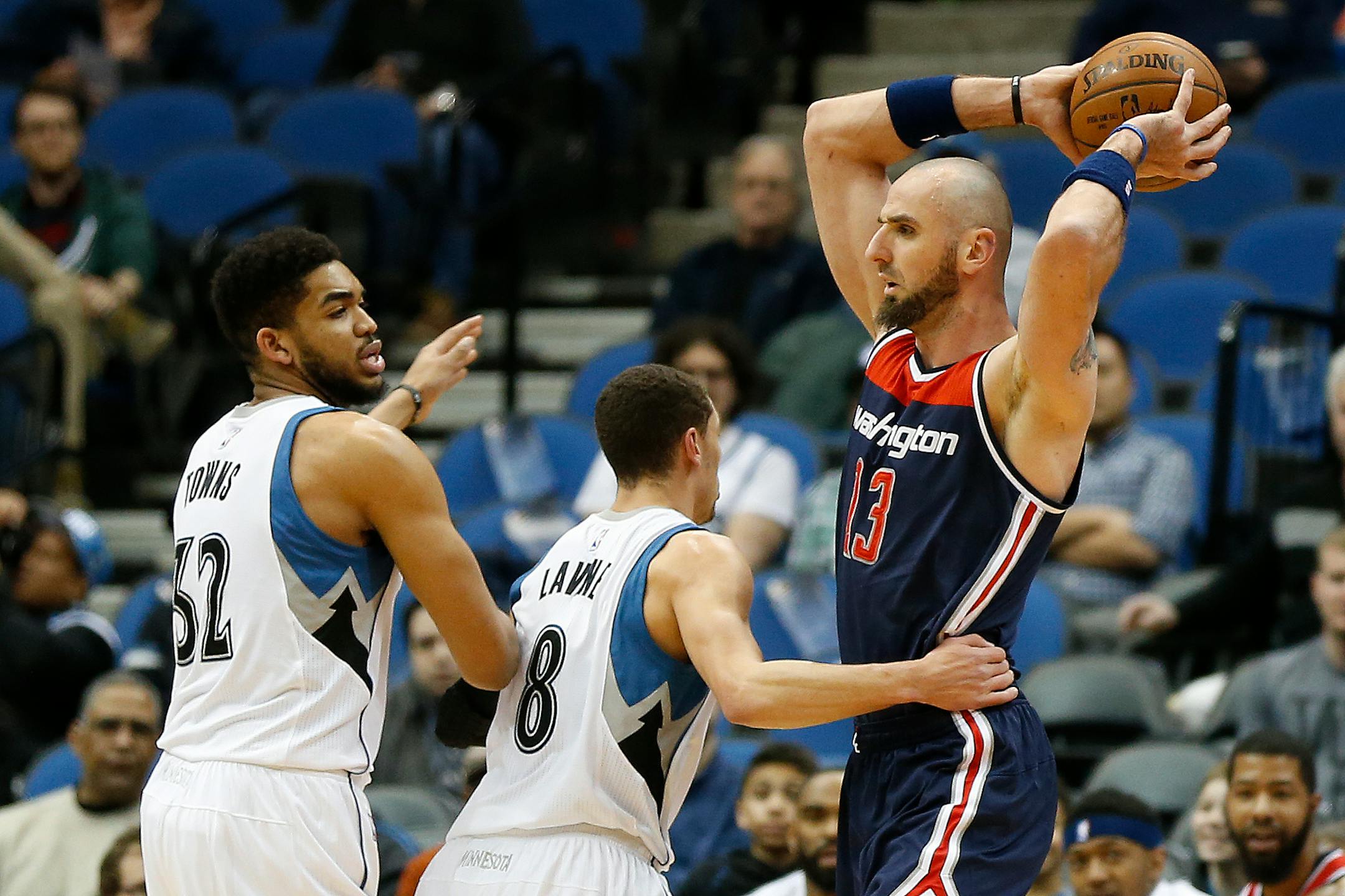 Washington Wizards center Marcin Gortat (13) protects the ball from Minnesota Timberwolves guard Zach LaVine (8) and forward Karl-Anthony Towns (32) in the first half of an NBA basketball game Wednesday, March 2, 2016 in Minneapolis. (AP Photo/Stacy Bengs)