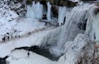 FILE -- Thrill seekers risk limb if not life to get an up and close look at the partially frozen Minnehaha Falls Tuesday, Jan. 3, 2016, in Minneapolis