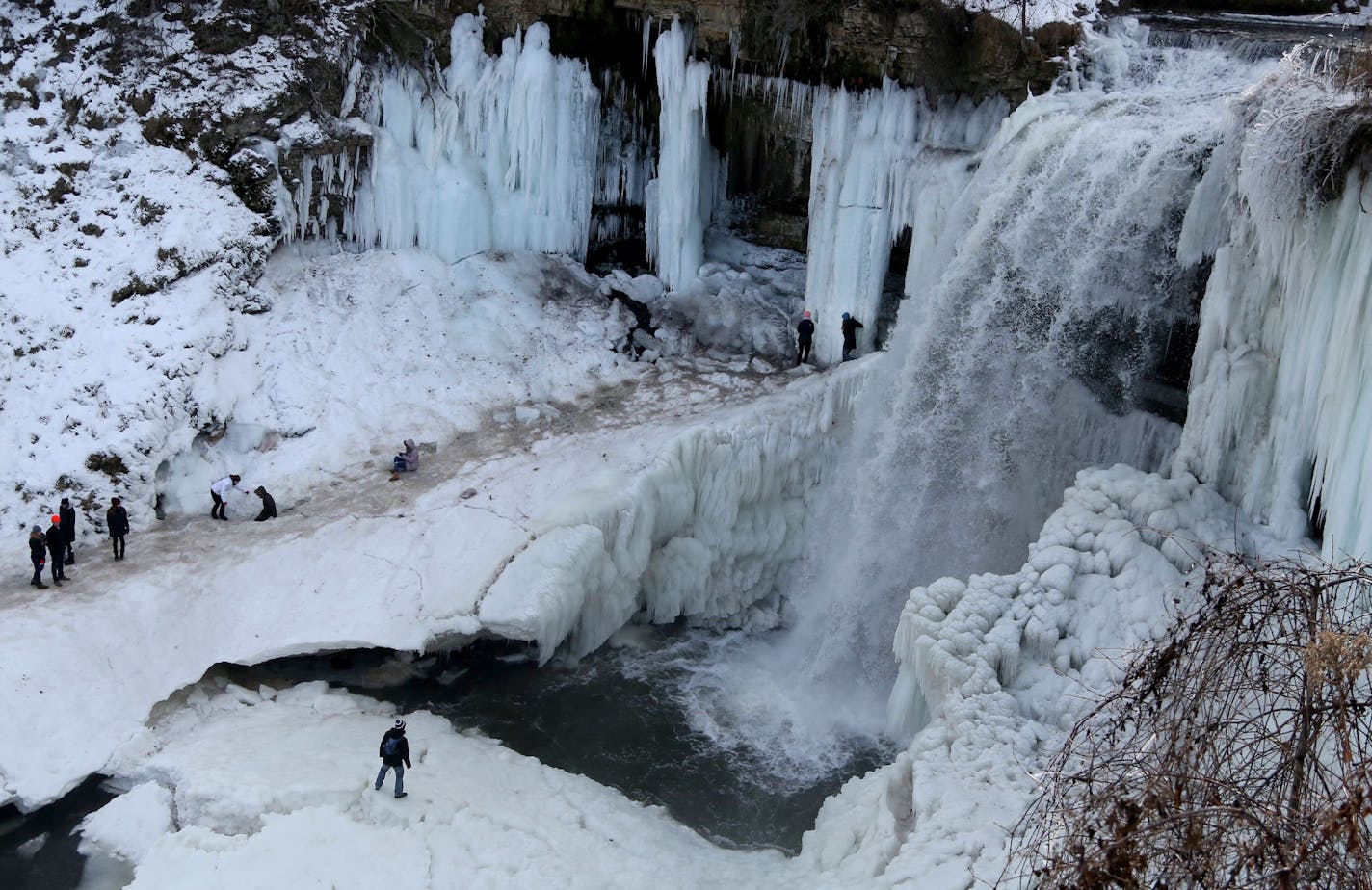 FILE -- Thrill seekers risk limb if not life to get an up and close look at the partially frozen Minnehaha Falls Tuesday, Jan. 3, 2016, in Minneapolis,