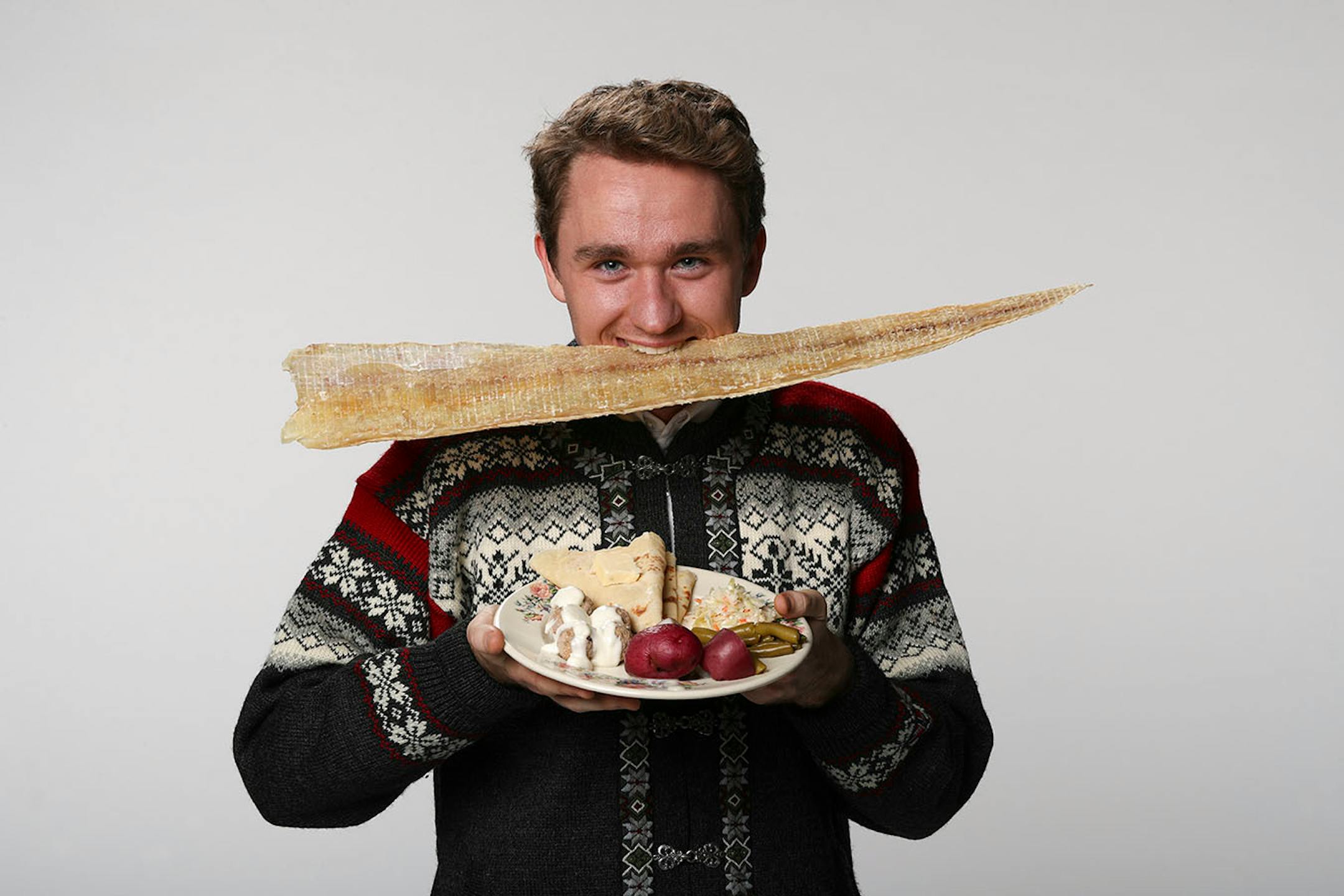 Nels Thompson with a dried cod, the basis of many a Scandinavian holiday meal. ] JEFF WHEELER ï jeff.wheeler@startribune.com Nels Thompson took over planning the traditional Scandinavian holiday meal at his church with the intent of making it appeal to twentysomethings like himself. He was photographed with dried cod in the StarTribune studio on Thursday afternoon, November 3, 2016.