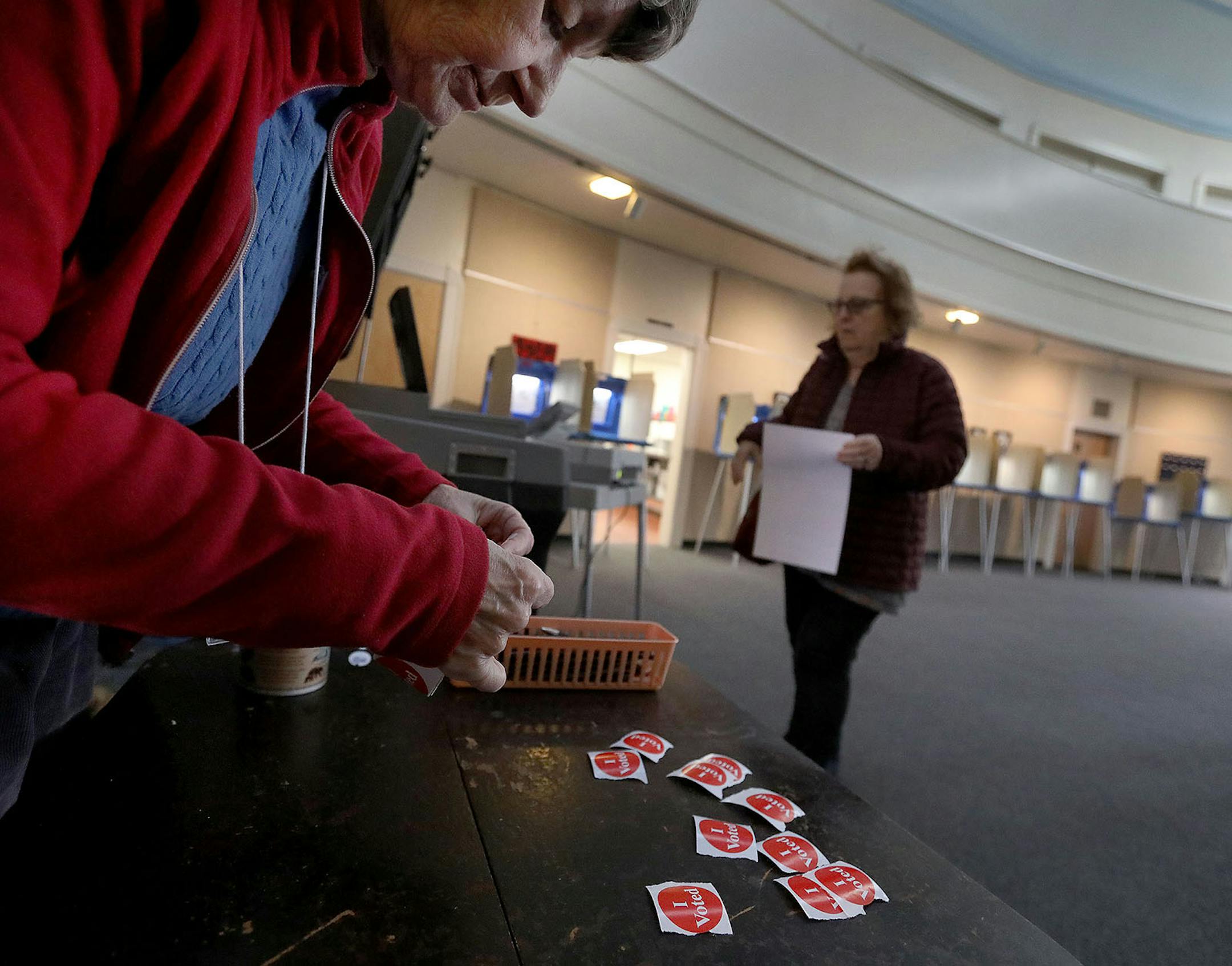 Volunteer poll worker Joan Kvidera prepares "I voted" stickers to hand out to those casting their ballot at First Congregational Church in Southeast Minneapolis during Tuesday's presidential primary.