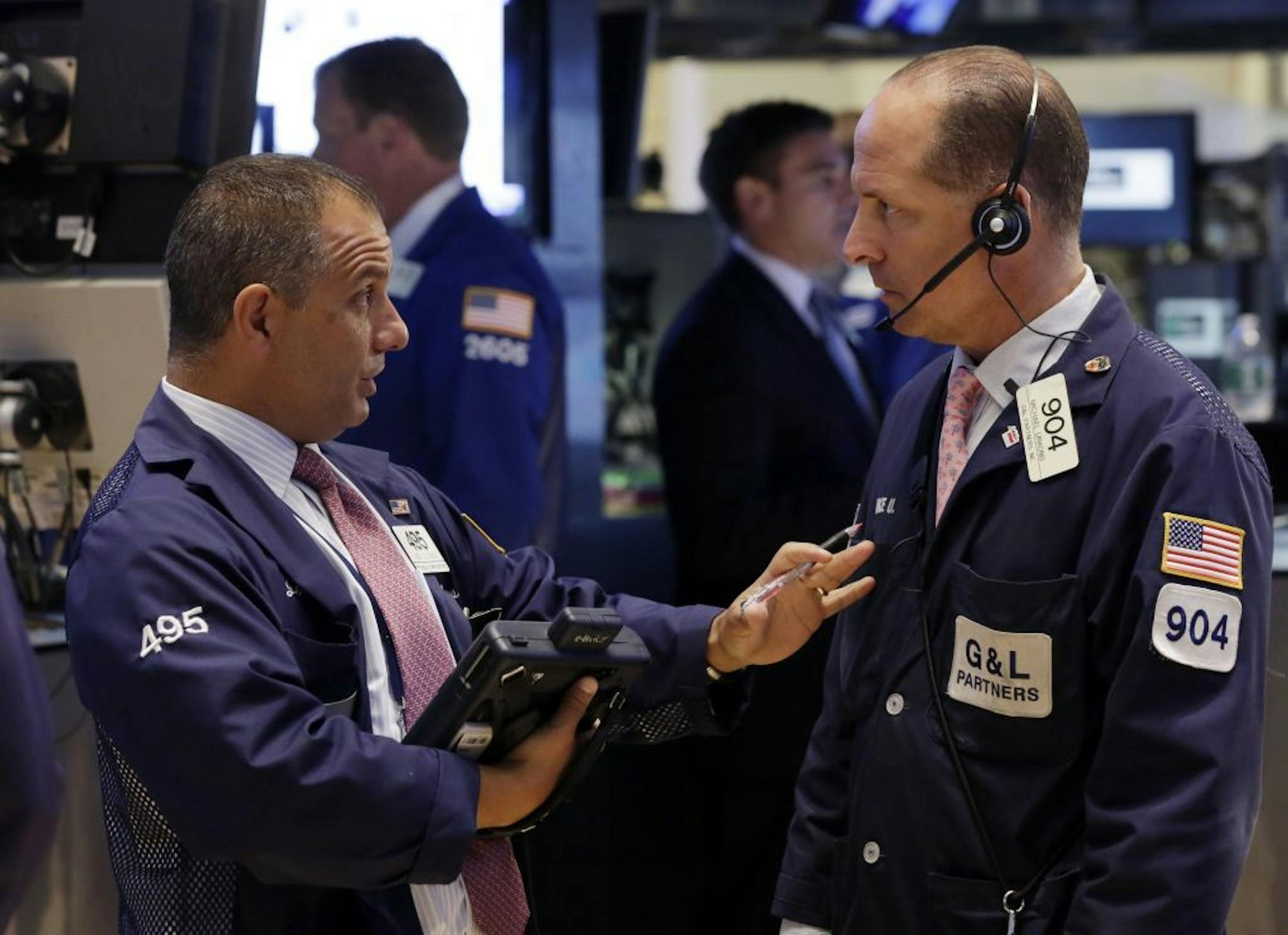 In this Monday, July 8, 2013 photo, traders Joel Lucchese, left, and Michael Urkonis confer on the floor of the New York Stock Exchange. Asian stock markets rebounded and European shares continued a global rally Tuesday July 9, 2013 following positive U.S. economic news as nervousness about an imminent scaling back of the Federal Reserve's monetary stimulus eased.