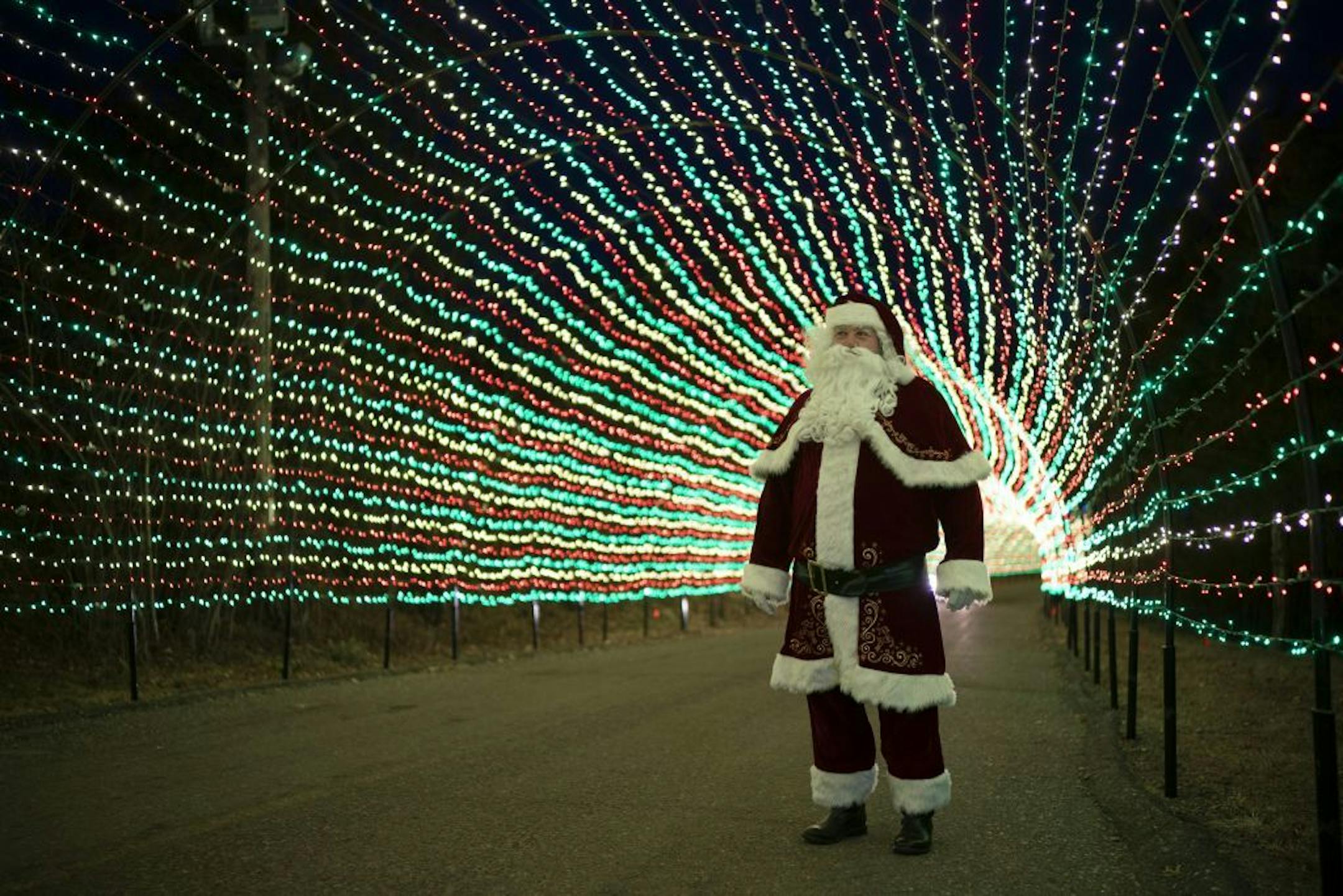 Santa, as portrayed by Lloyd Larrieu, in the 540 foot long entrance tunnel lit with 220,000 lights.