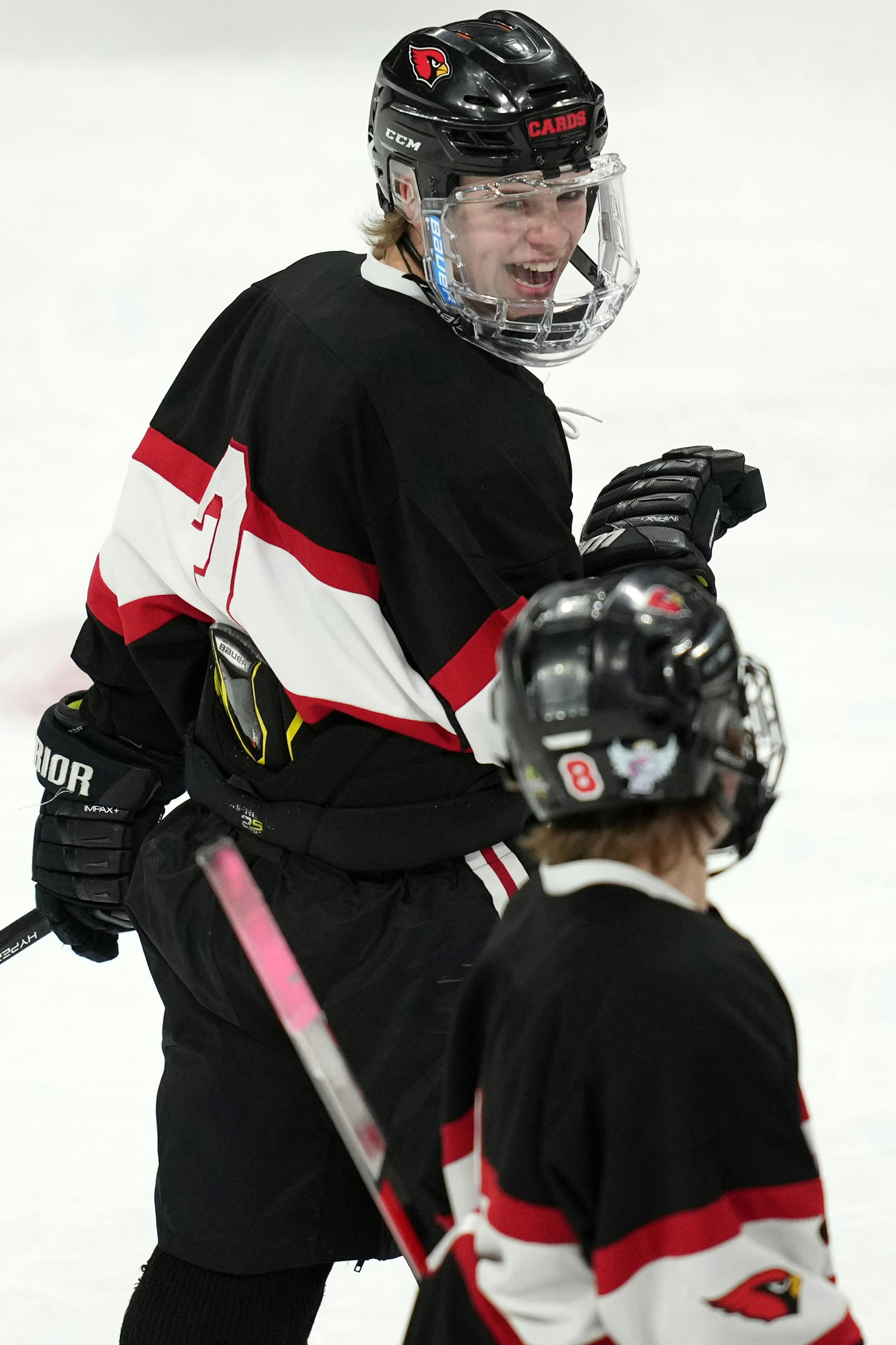 Alexandria forward Leonard Kompelien (3) smiles after scoring in the first period of a MSHSL Class 1A quarterfinal hockey game between Alexandria and Mahtomedi.