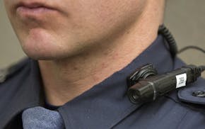In a Friday, March 6, 2015 photo, a body cam with flexible mounting options for multiple officers at one scene is shown by a Grand Rapids police offic