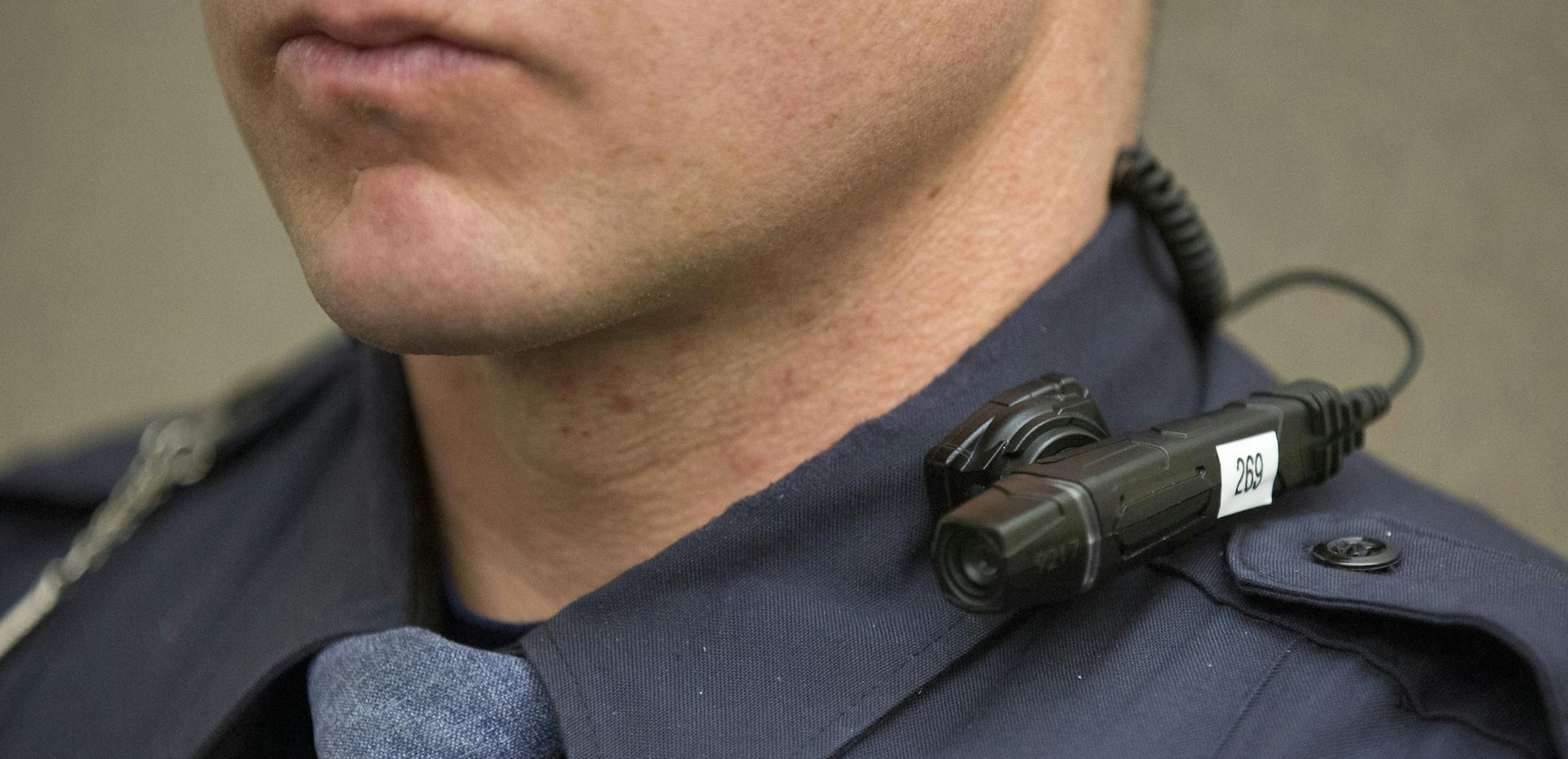In a Friday, March 6, 2015 photo, a body cam with flexible mounting options for multiple officers at one scene is shown by a Grand Rapids police officer during a media event at the Grand Rapids Police Department Headquarters in Grand Rapids, Mich. Grand Rapids City Commission on Tuesday, March 10, authorized spending $674,124 from a special tax fund to pay startup costs for 200 body cams. (AP Photo/The Grand Rapids Press, Hugh Carey) ALL LOCAL TELEVISION OUT; LOCAL TELEVISION INTERNET OUT ORG XM