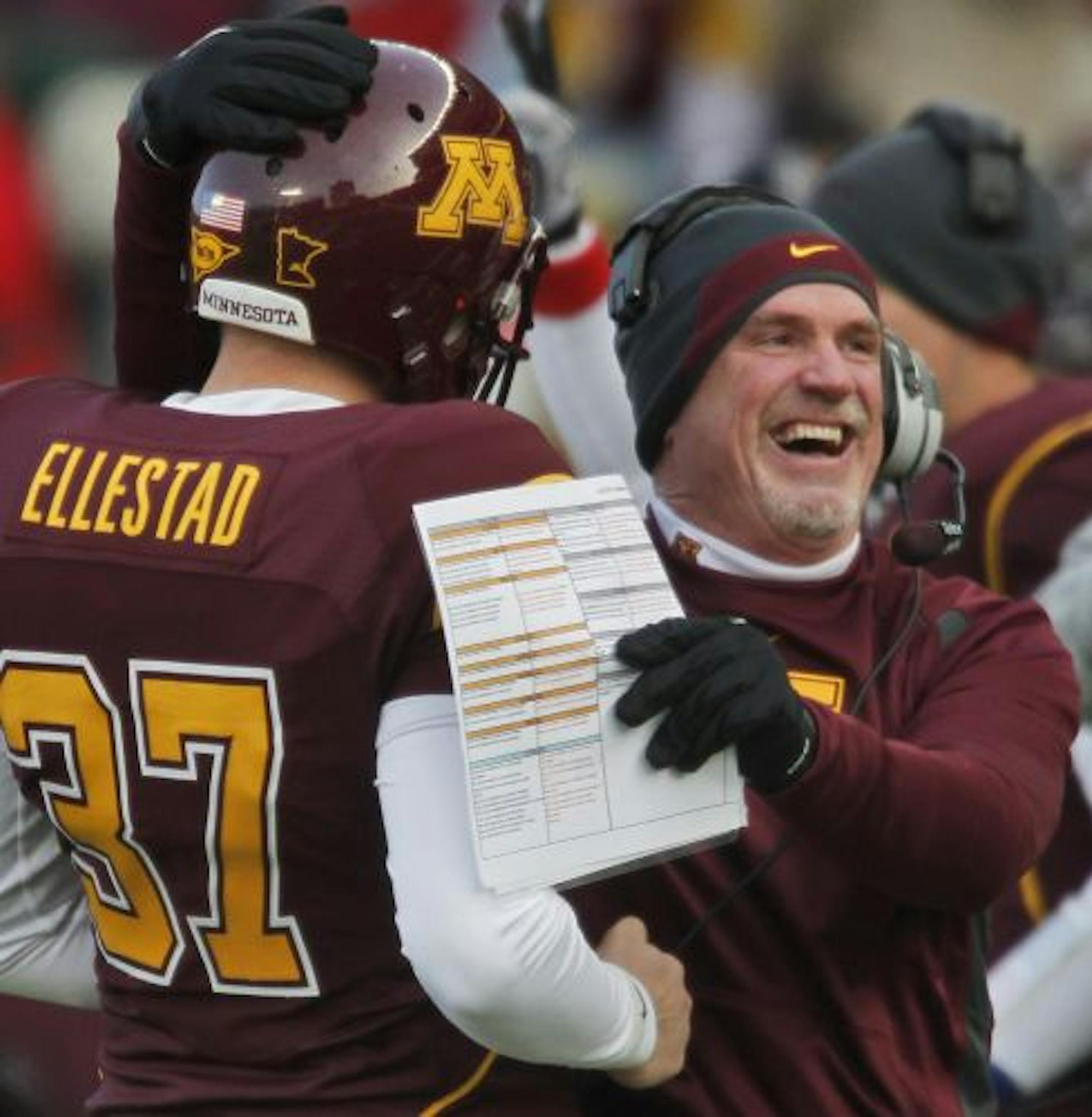 Gophers interim head coach Jeff Horton hugged Eric Ellestad after he recovered an on-side kick in first half action.