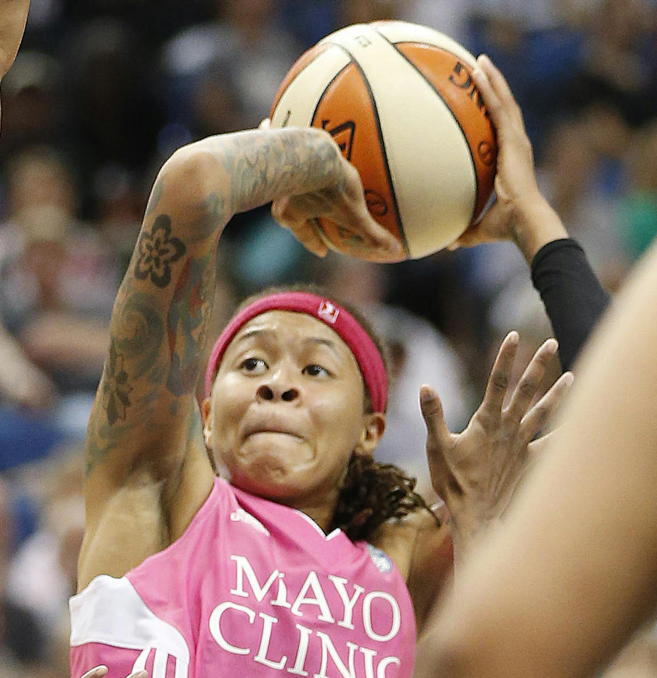 Minnesota Lynx guard Seimone Augustus (33) shoots as San Antonio Stars guard Shenise Johnson (42) defends during the first half of a WNBA basketball game, Friday, July 25, 2014, in Minneapolis. The Lynx won 88-78. Augustus scored 17 points. (AP Photo/Stacy Bengs)