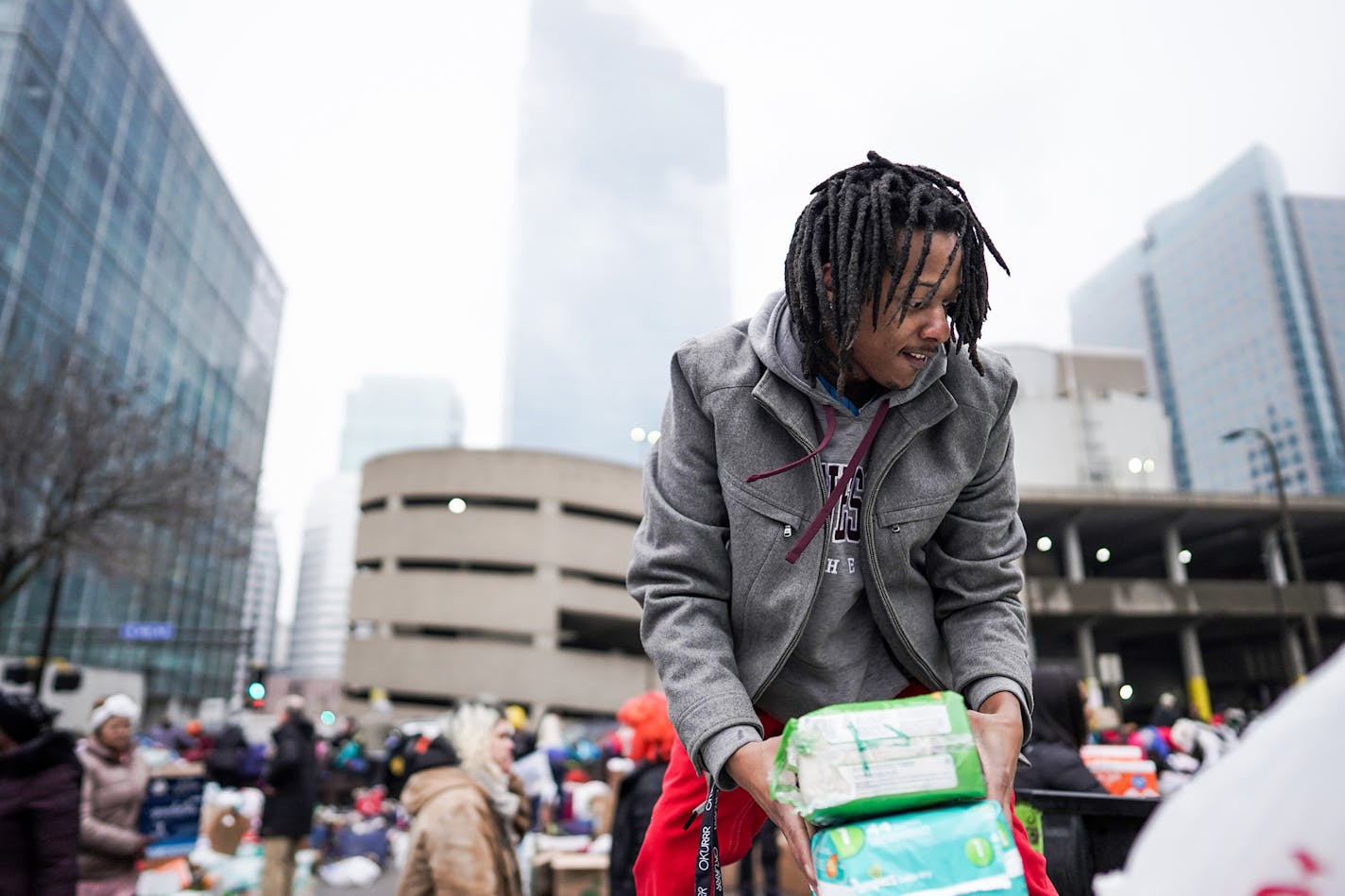 Volunteer Robert Hill of Minneapolis helped load donations onto trucks as residents were bussed to temporary shelters. ] MARK VANCLEAVE ¥ Hundreds of people donated diapers, clothing and personal items after early morning fire tore through the Francis Drake Hotel apartments Wednesday, Dec. 25, 2019 in Minneapolis. The Francis Drake Hotel served as transitional housing for more than 200 people.