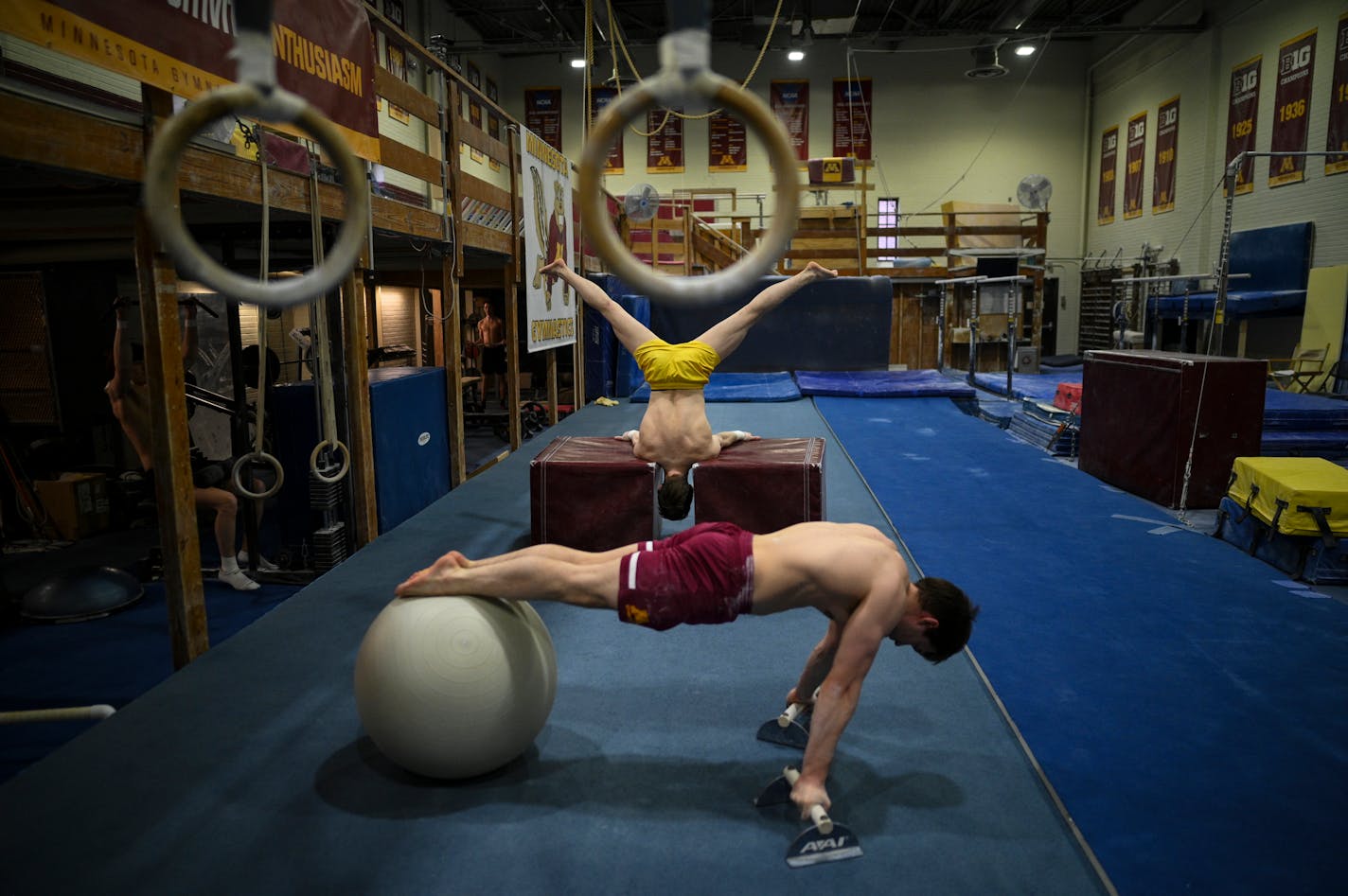 University of Minnesota Men's Gymnastics club teammates perform strength and conditioning exercises Monday, April 25, 2022 at Cooke Hall in Minneapolis, Minn.. One season after the Gophers men's gymnastics team was cut, team members still compete for a club team in virtual meets, and the nationals start May 14. ] AARON LAVINSKY• Aaron.lavinsky@startribune.com