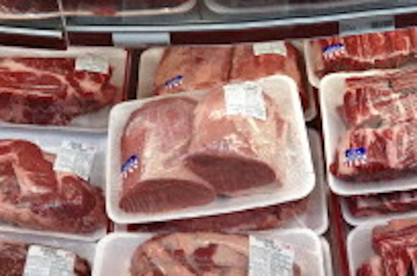 FILE - In this Nov. 2, 2013 file photo, various cuts of beef and port are displayed for sale in the meat department at a discount market in Arlington, Va. Cattle groups from the U.S. and Canada are upset that a new Farm Bill passed by the House on Wednesday, Jan. 29, 2014, fails to make changes to country-of-origin labeling requirements. The rules require detailed labels about the origins of beef, pork and chicken sold in U.S. stores. (AP Photo/J. Scott Applewhite, File)