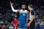 Mike Conley of the Wolves has a friendly discussion with a referee during a game on April 12 at Target Center. The point guard was named the NBA Teamm
